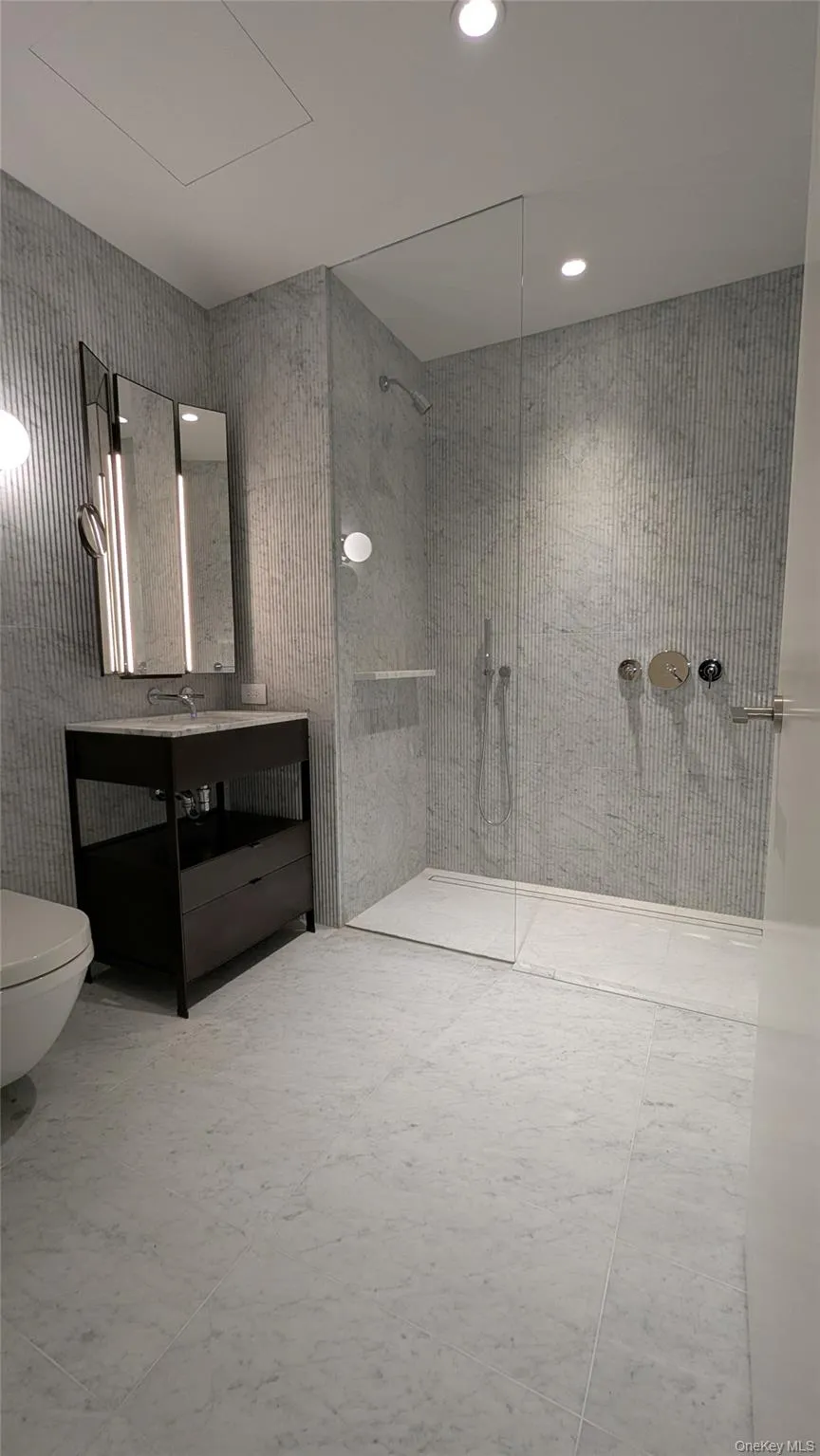 Bathroom with a walk in shower, vanity, and recessed lighting Bathroom with a walk in shower, vanity, and recessed lighting