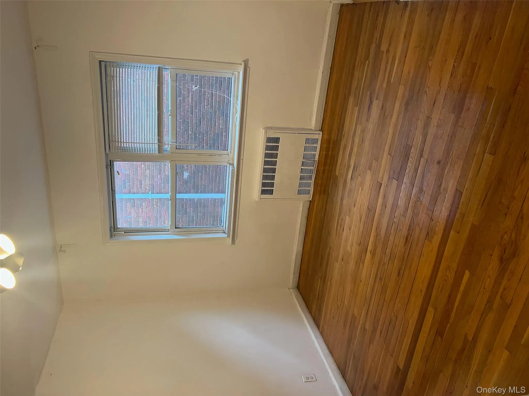 Spare room featuring radiator and wood-type flooring Spare room featuring radiator and wood-type flooring