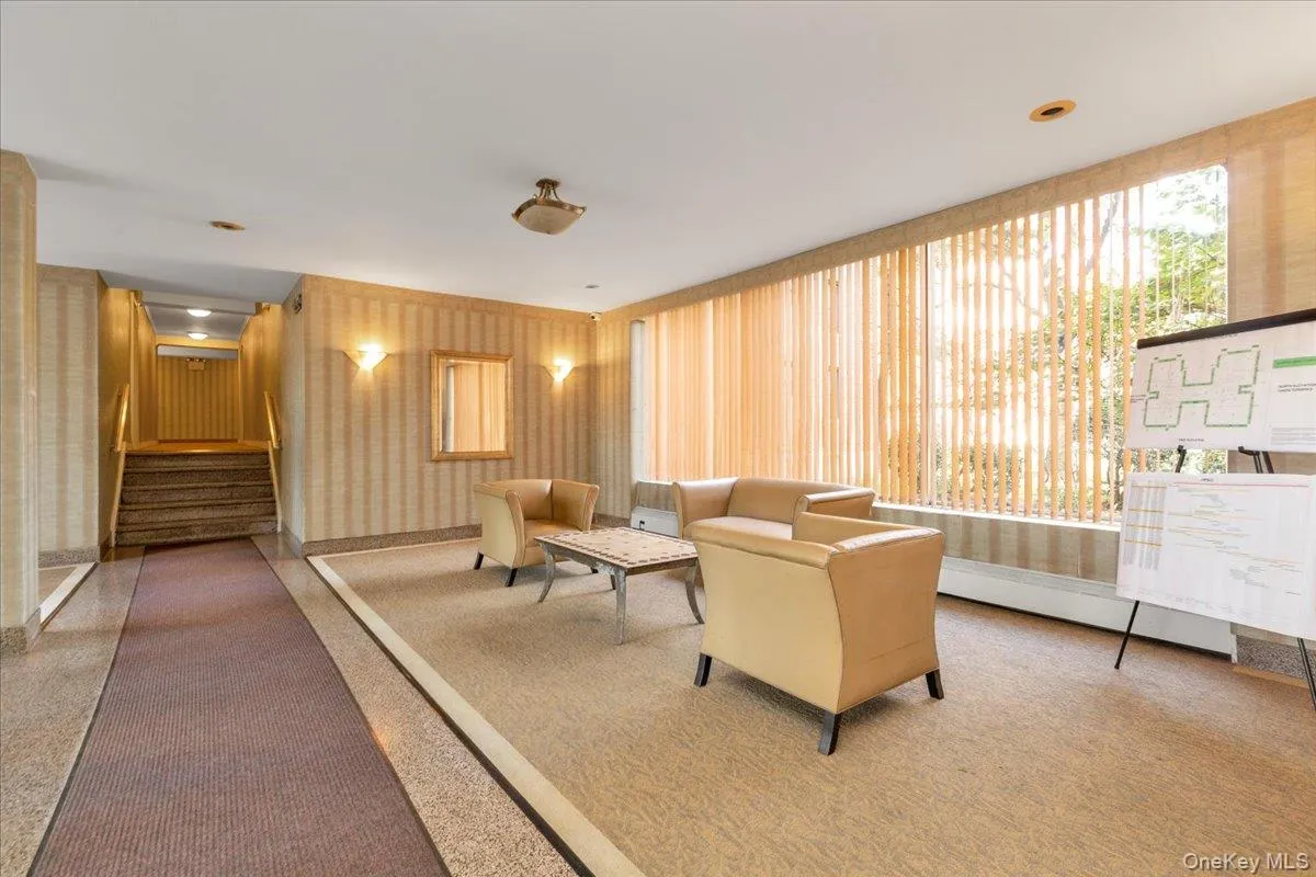 Building lobby featuring stairs, wallpapered walls, and recessed lighting Building lobby featuring stairs, wallpapered walls, and recessed lighting