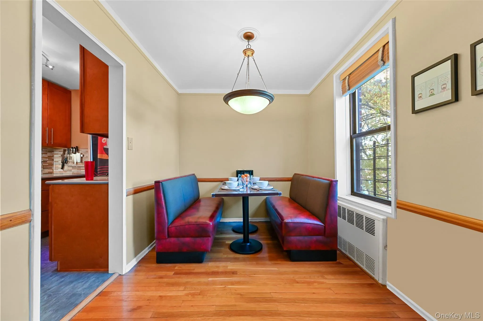 Sitting room featuring radiator, light wood-type flooring, and ornamental molding Sitting room featuring radiator, light wood-type flooring, and ornamental molding