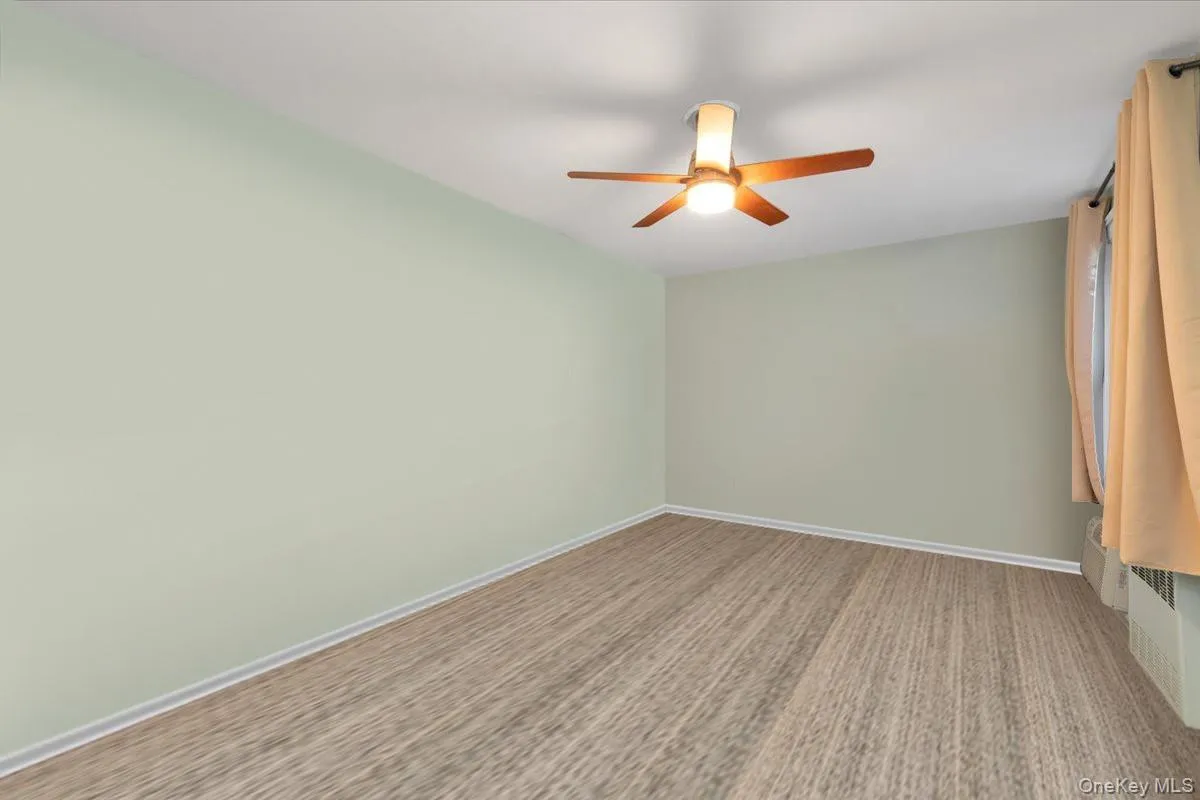 Spare room featuring baseboards and a ceiling fan Spare room featuring baseboards and a ceiling fan