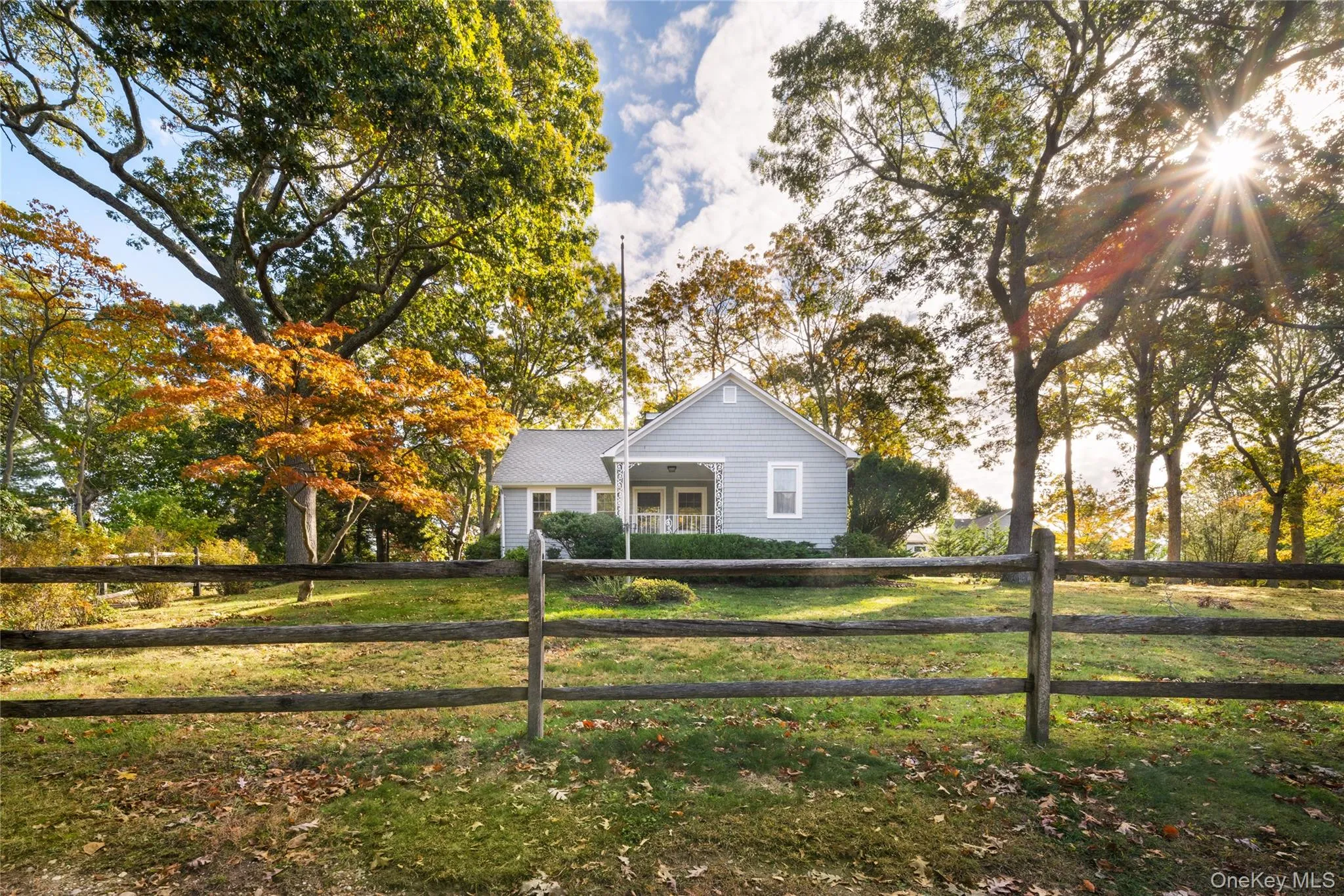 View of front of property with a fenced front yard and view of scattered trees View of front of property with a fenced front yard and view of scattered trees