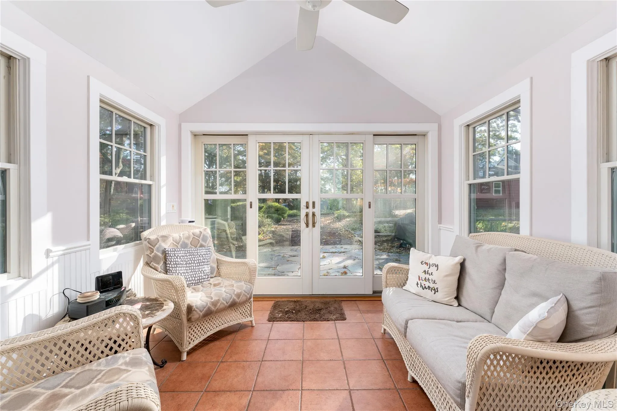 Sunroom / solarium featuring tile patterned floors and french doors Sunroom / solarium featuring tile patterned floors and french doors