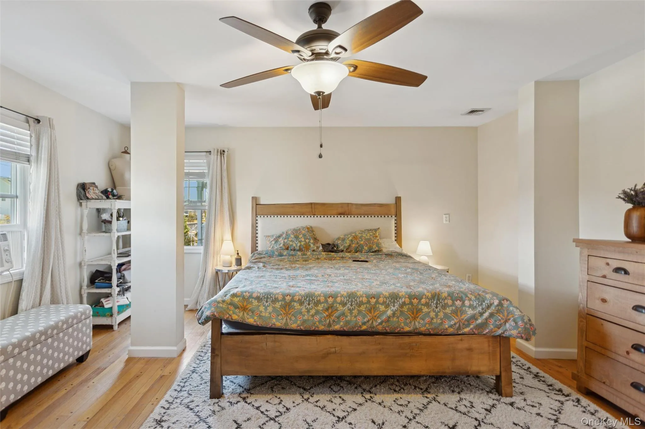 Bedroom featuring light wood finished floors and ceiling fan Bedroom featuring light wood finished floors and ceiling fan