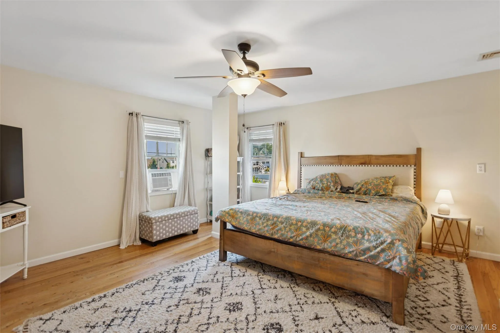 Bedroom featuring light wood finished floors and ceiling fan Bedroom featuring light wood finished floors and ceiling fan