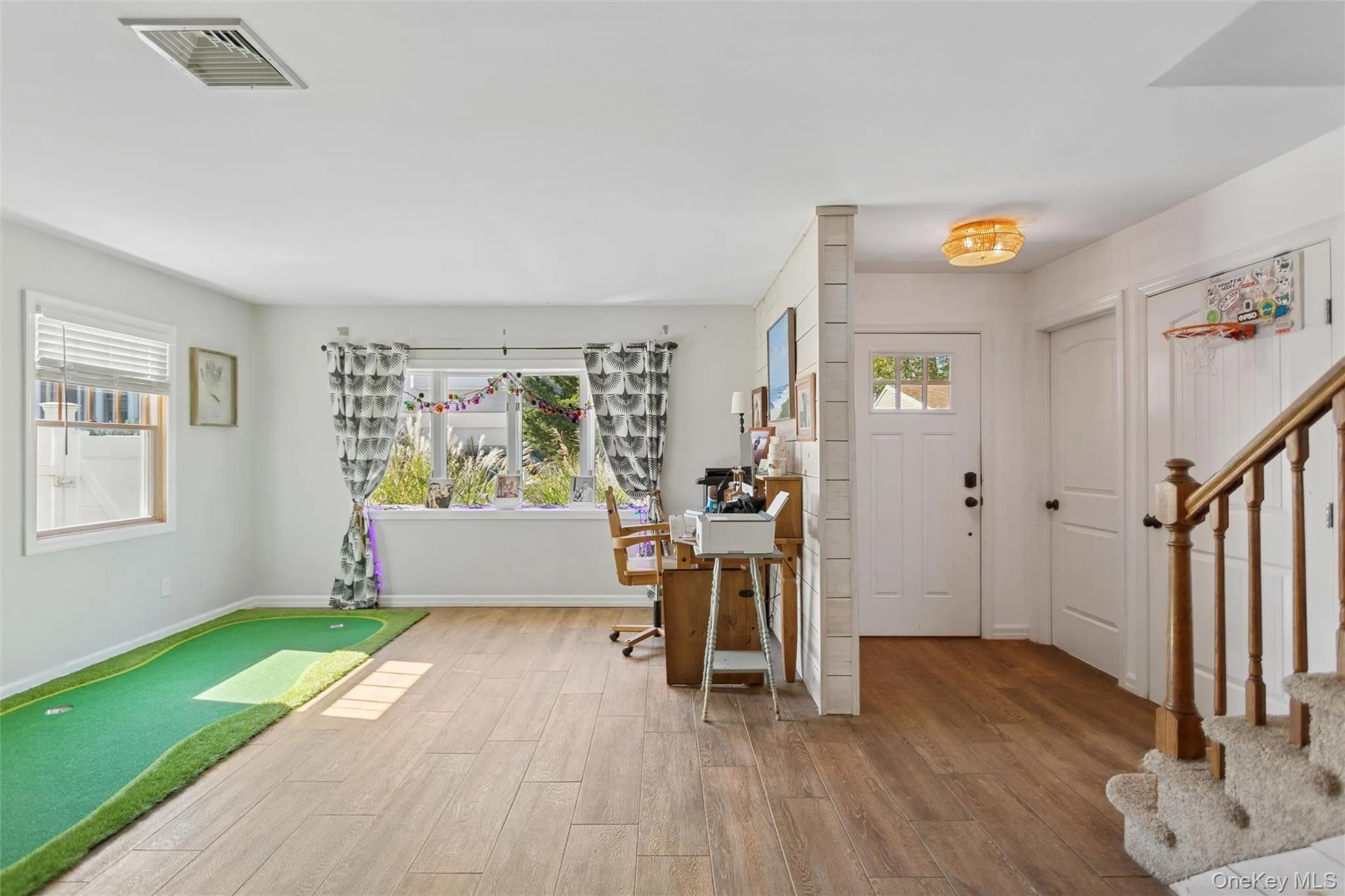 Entrance foyer featuring wood finished floors and stairway Entrance foyer featuring wood finished floors and stairway