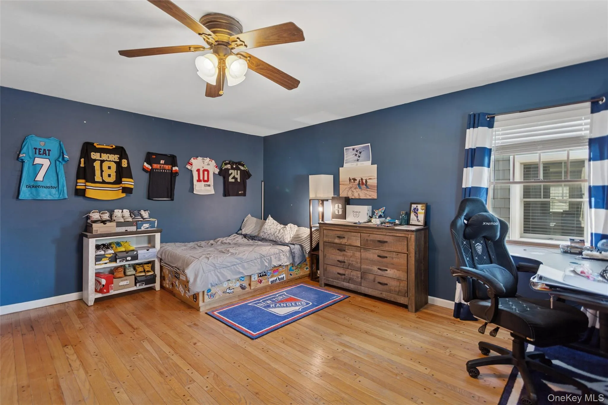 Bedroom with light wood-style floors, a ceiling fan, and a desk Bedroom with light wood-style floors, a ceiling fan, and a desk