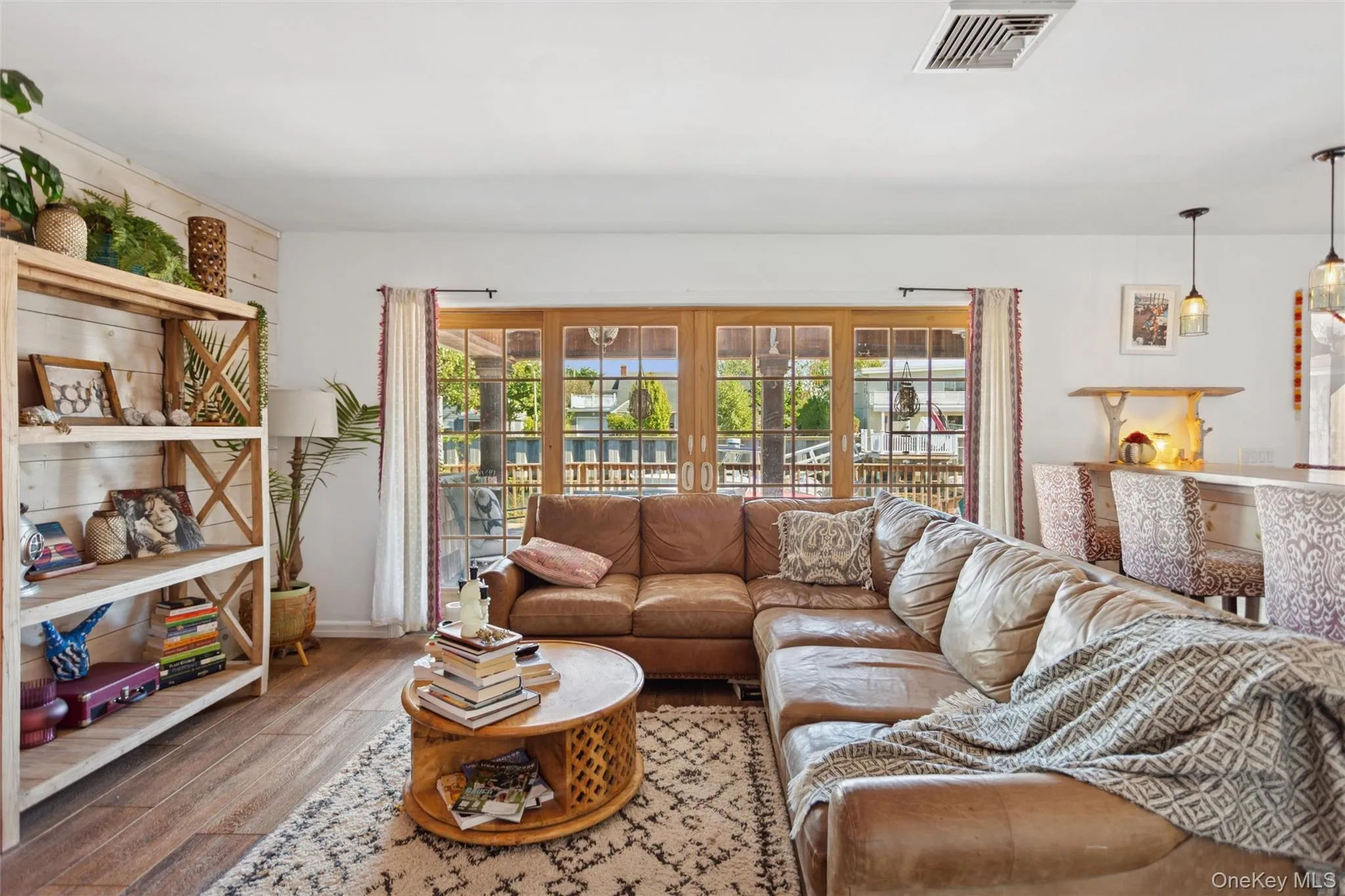 Living room with wood finished floors and a water view Living room with wood finished floors and a water view