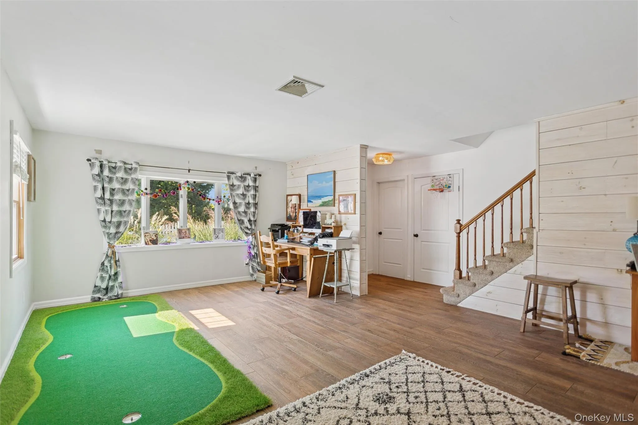 Home office featuring wood finished floors and wooden walls Home office featuring wood finished floors and wooden walls