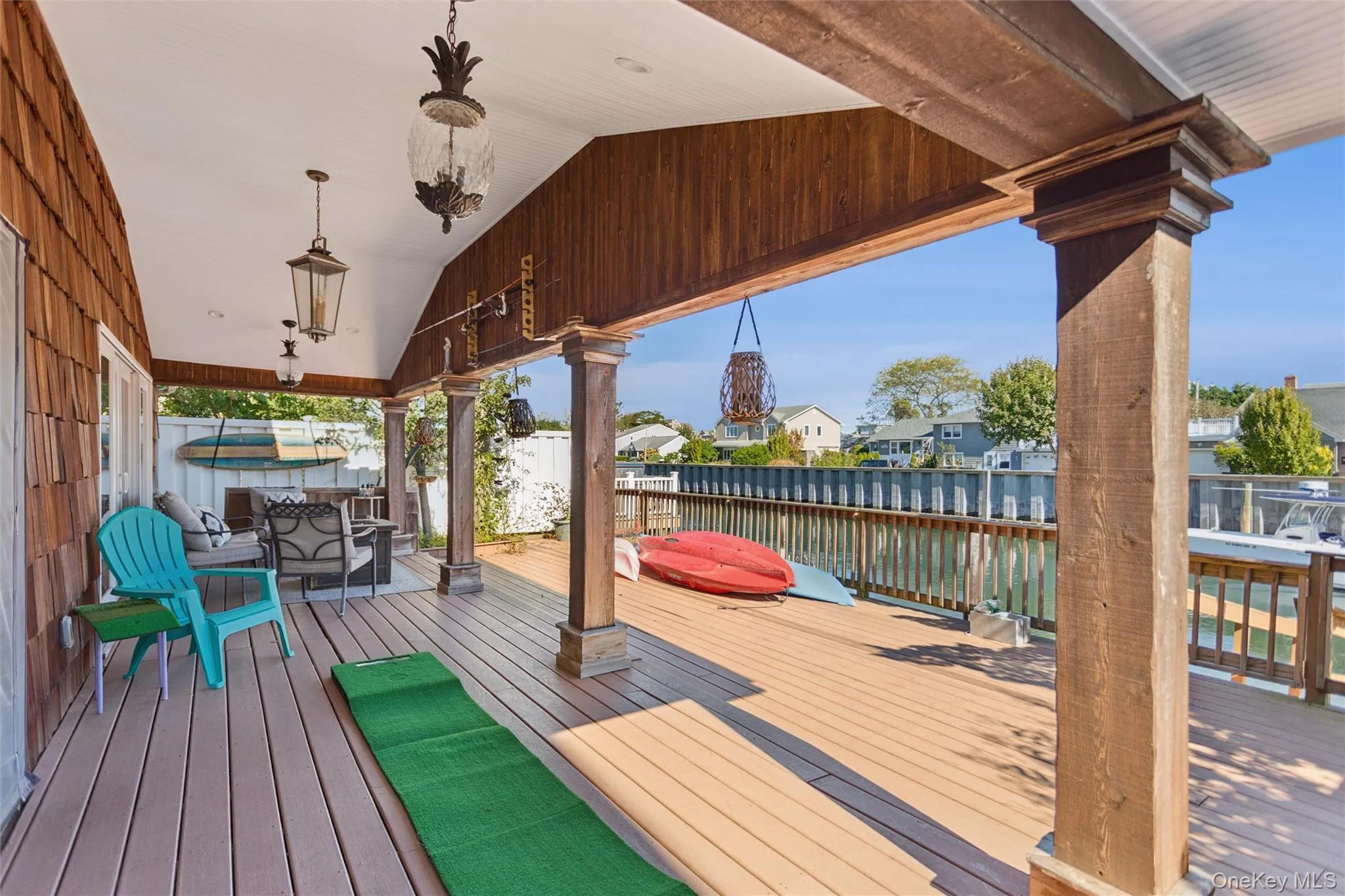 Deck featuring a water view, a residential view, and outdoor dining space Deck featuring a water view, a residential view, and outdoor dining space