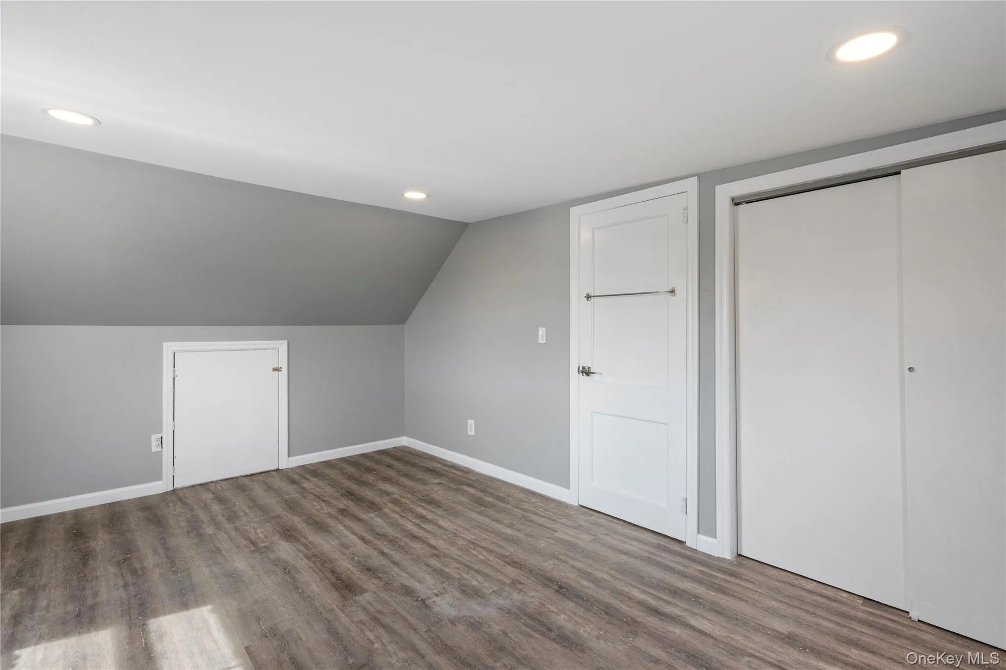 Bonus room with recessed lighting, wood finished floors, and lofted ceiling Bonus room with recessed lighting, wood finished floors, and lofted ceiling