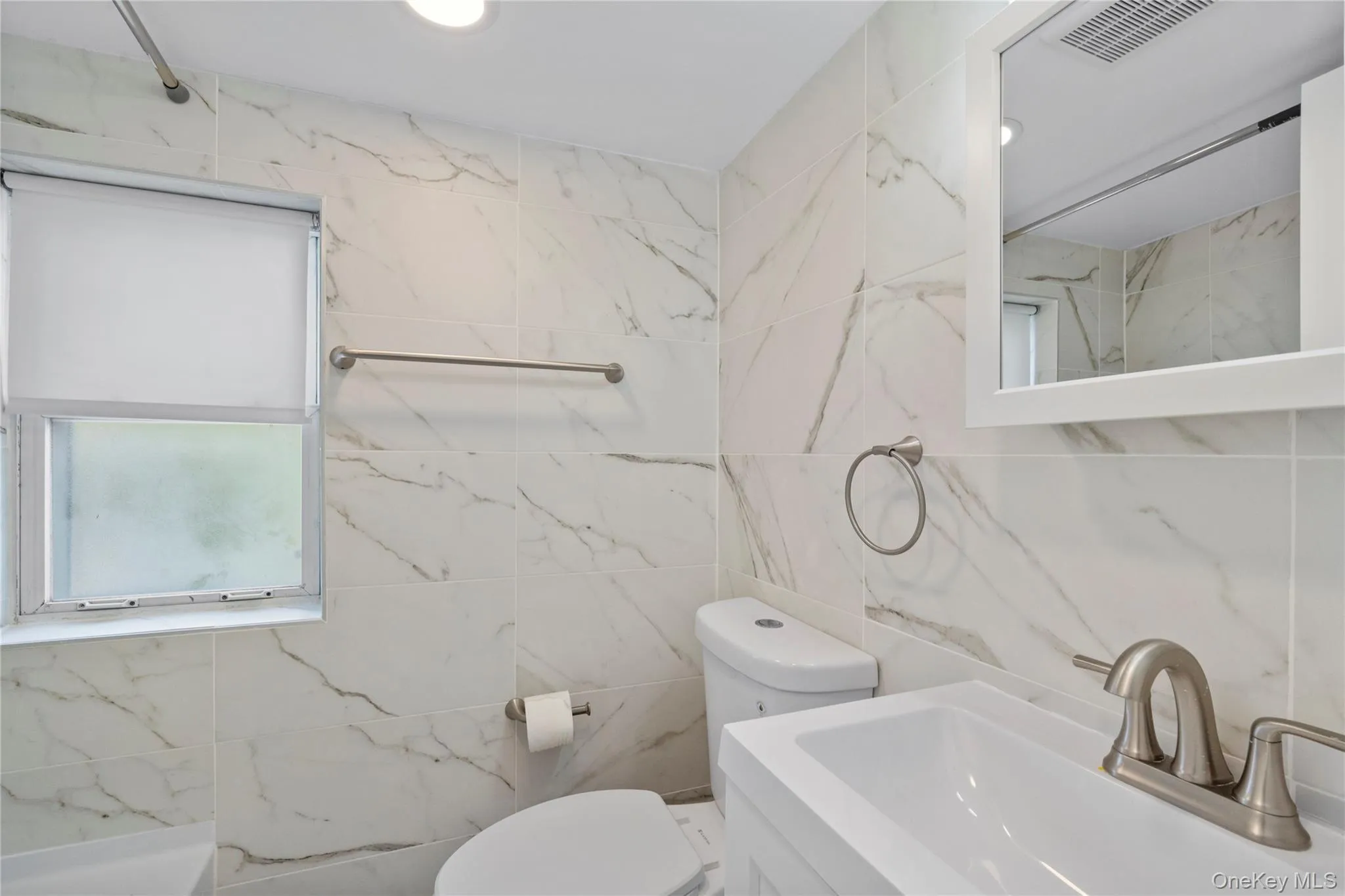 Full bath with vanity, tile walls, a shower, recessed lighting, and a tub to relax in Full bath with vanity, tile walls, a shower, recessed lighting, and a tub to relax in