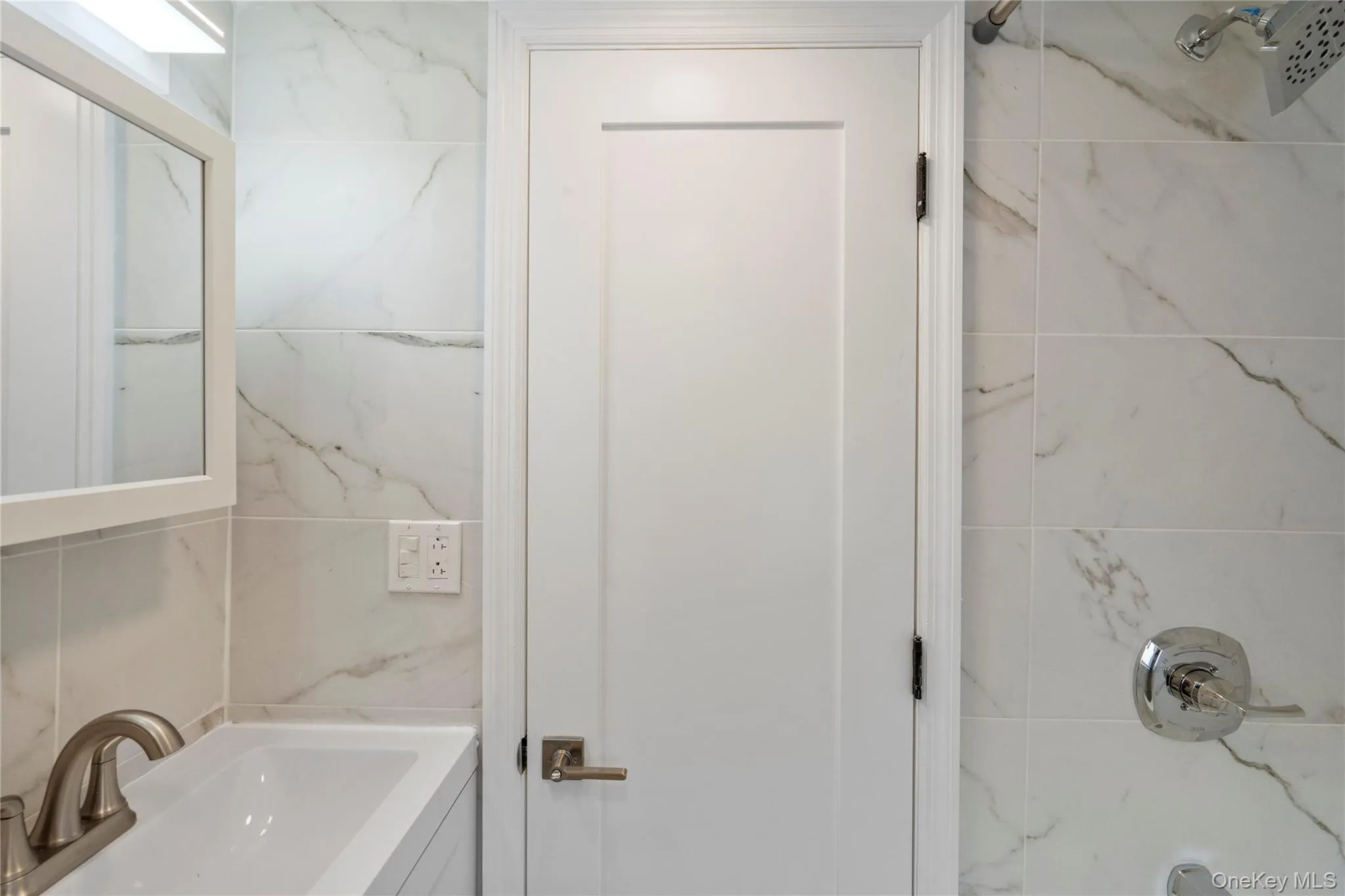 Bathroom featuring vanity and tile walls Bathroom featuring vanity and tile walls