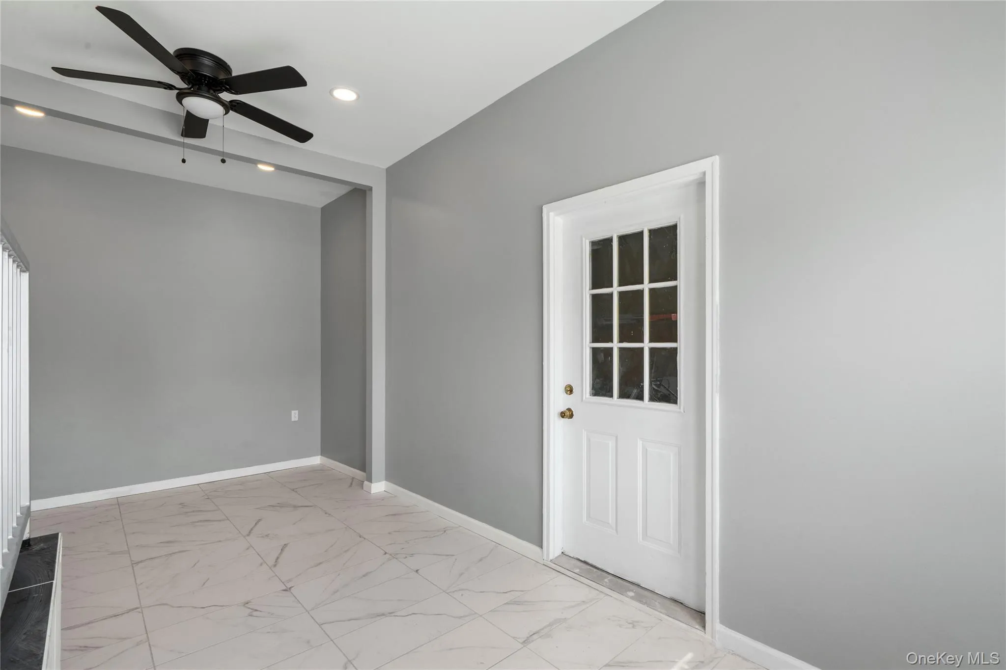 Empty room featuring light marble finish floors, a ceiling fan, and recessed lighting Empty room featuring light marble finish floors, a ceiling fan, and recessed lighting