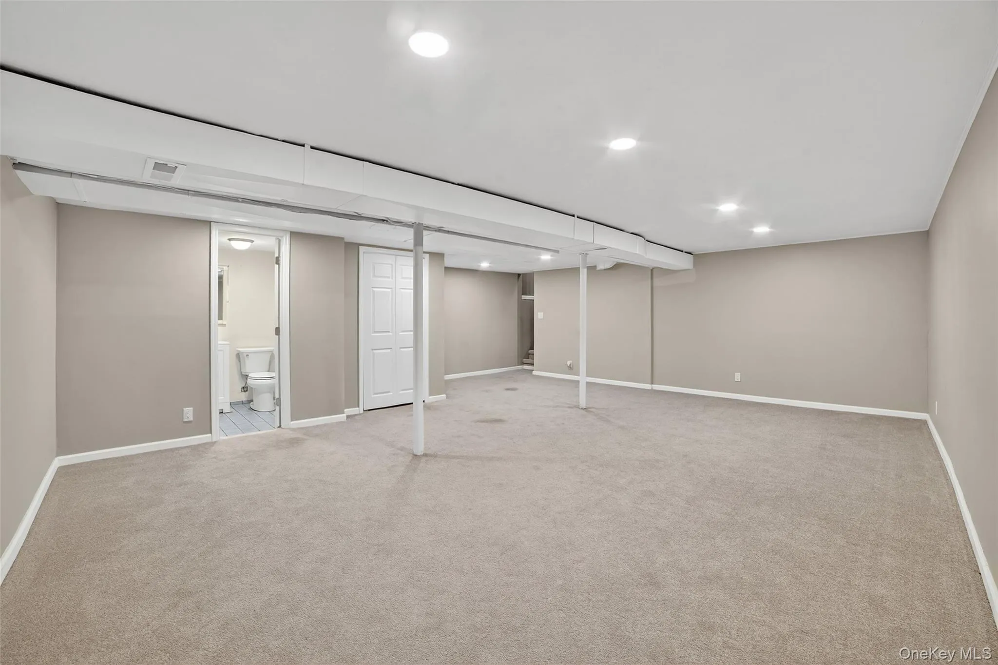 Finished basement featuring carpet floors and recessed lighting Finished basement featuring carpet floors and recessed lighting