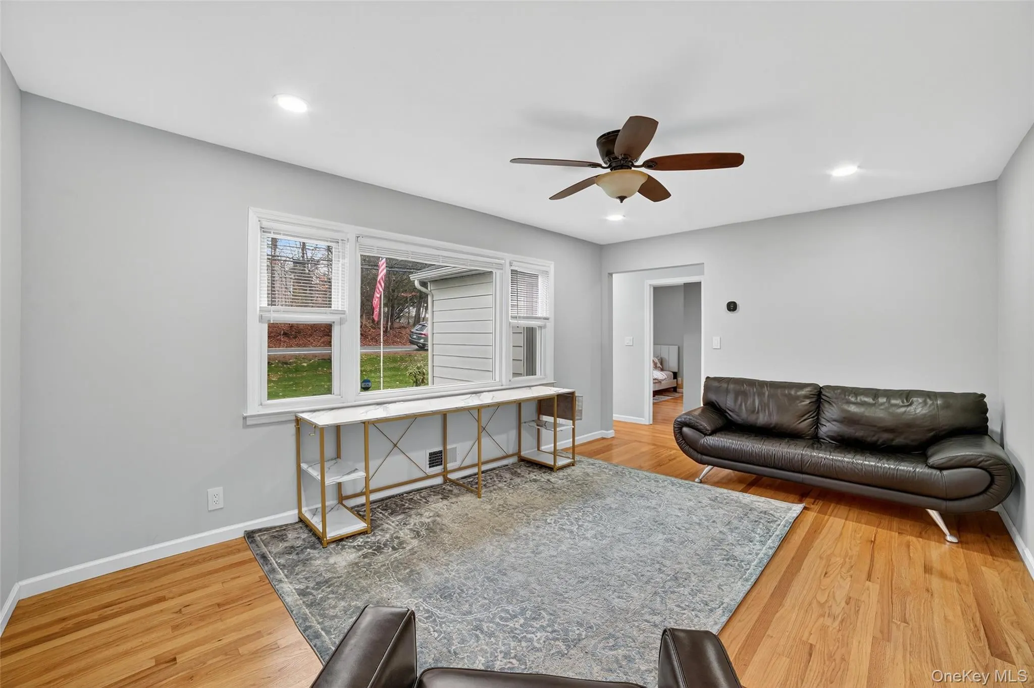 Living room featuring recessed lighting, light wood-style flooring, and ceiling fan Living room featuring recessed lighting, light wood-style flooring, and ceiling fan