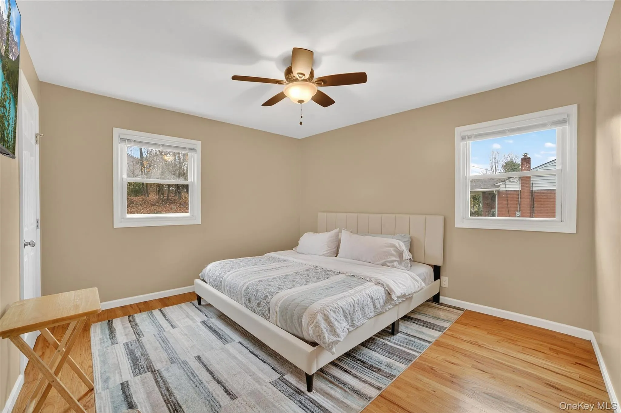 Bedroom with light wood-style floors and ceiling fan Bedroom with light wood-style floors and ceiling fan