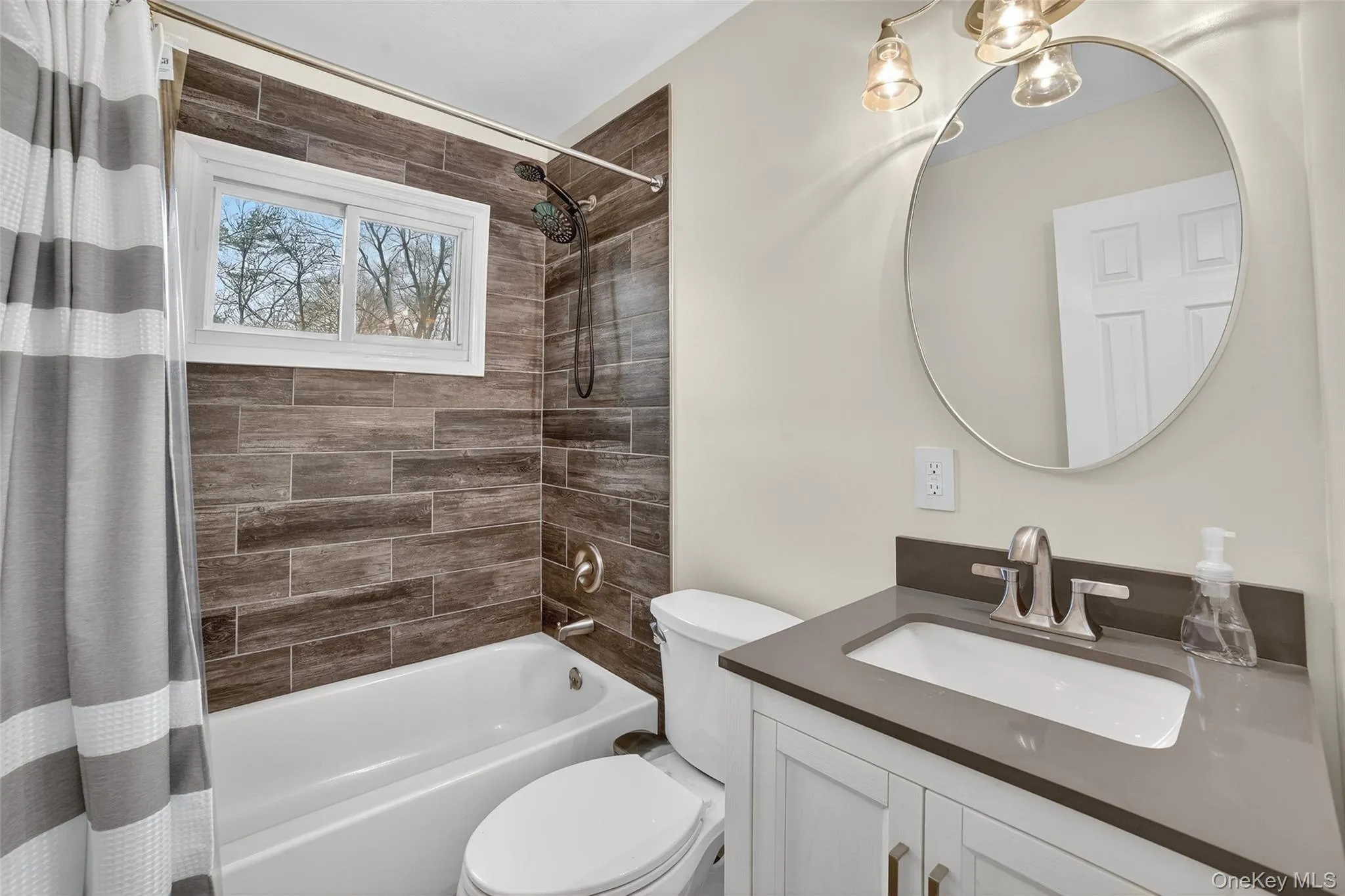 Bathroom featuring shower / bath combination with curtain and vanity Bathroom featuring shower / bath combination with curtain and vanity