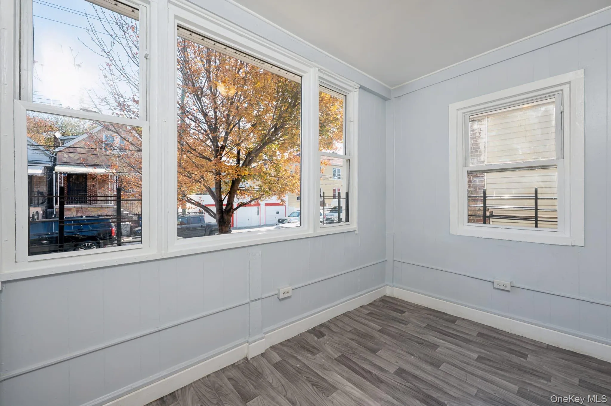 Spare room with dark wood finished floors and baseboards Spare room with dark wood finished floors and baseboards