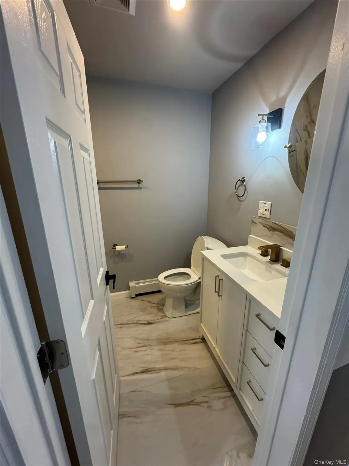 Bathroom with vanity and baseboard heating Bathroom with vanity and baseboard heating