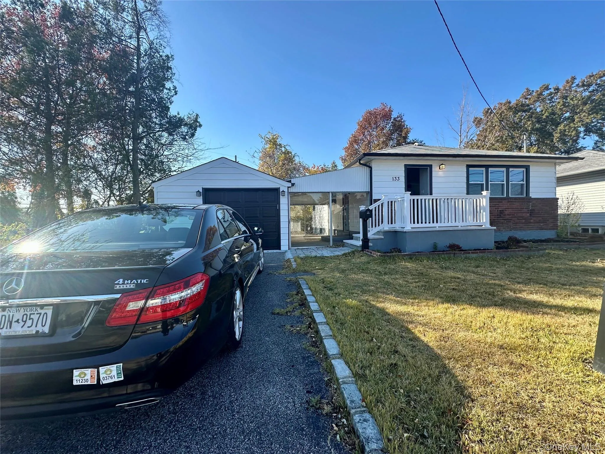 View of front facade with a front lawn and an outbuilding View of front facade with a front lawn and an outbuilding