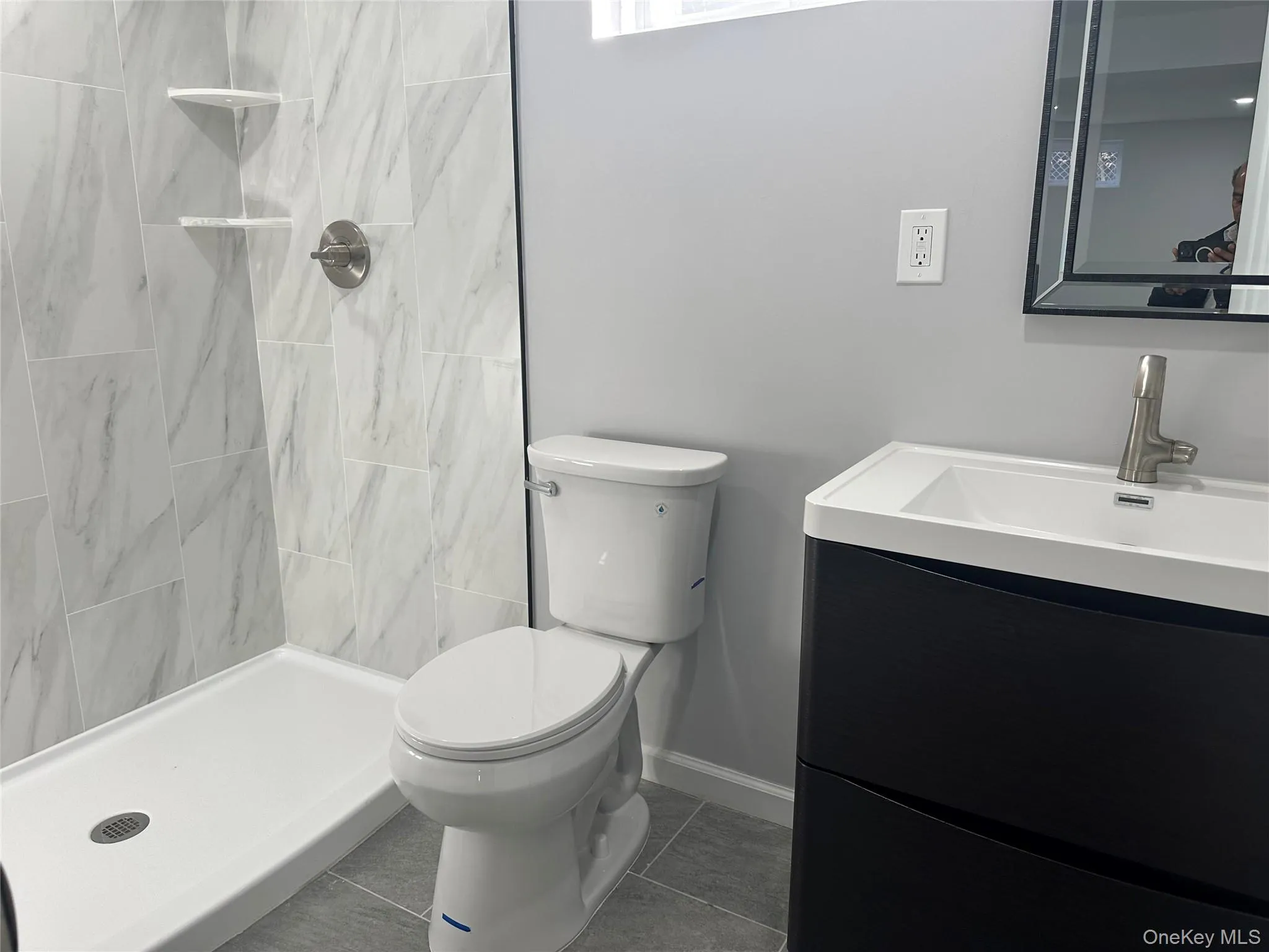 Full bathroom featuring a shower stall, vanity, and tile patterned flooring Full bathroom featuring a shower stall, vanity, and tile patterned flooring