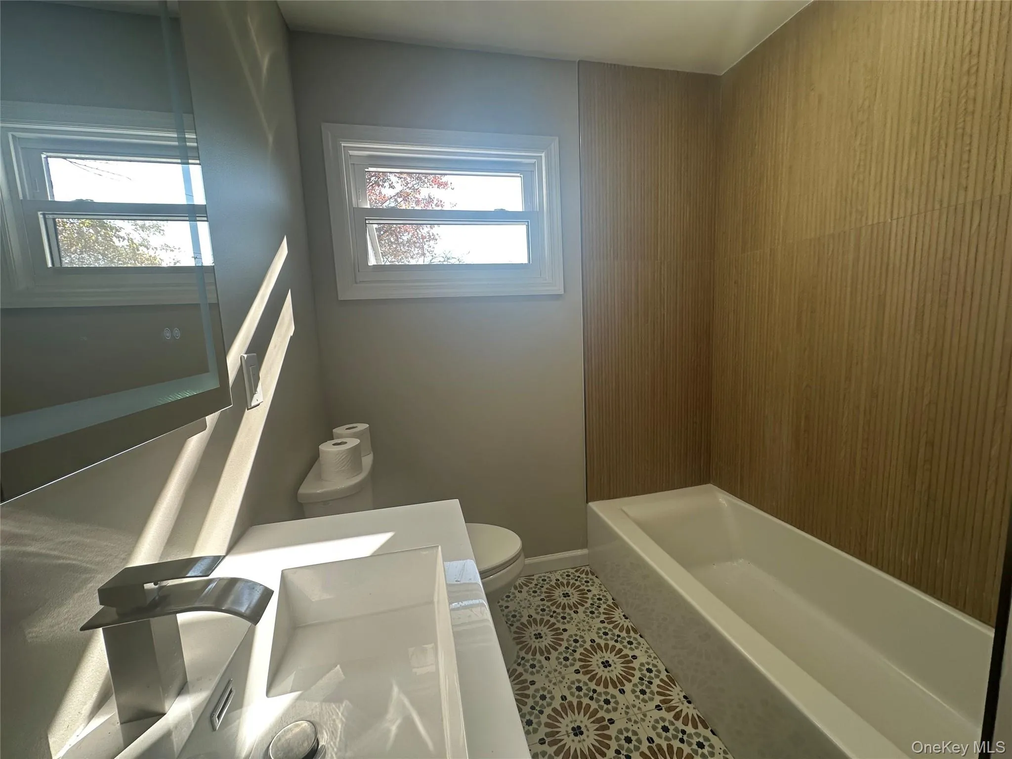 Bathroom with tile patterned flooring, vanity, and shower / tub combination Bathroom with tile patterned flooring, vanity, and shower / tub combination