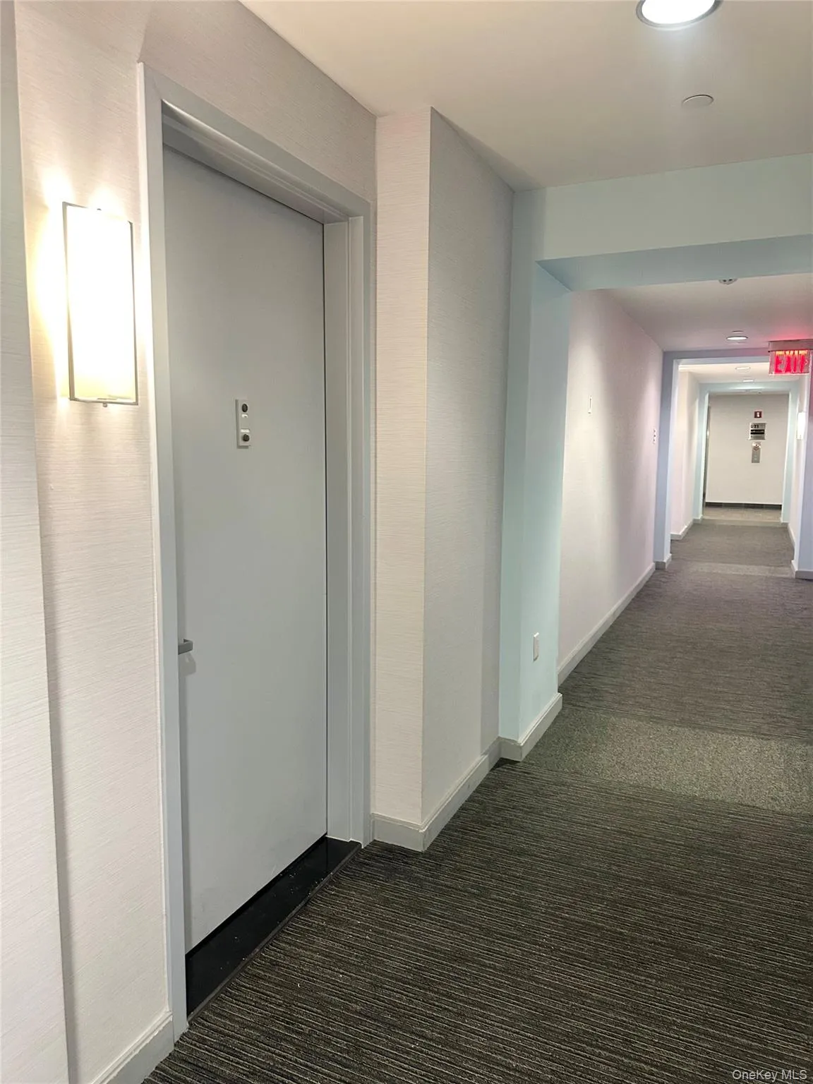 Hall featuring dark carpet and recessed lighting Hall featuring dark carpet and recessed lighting