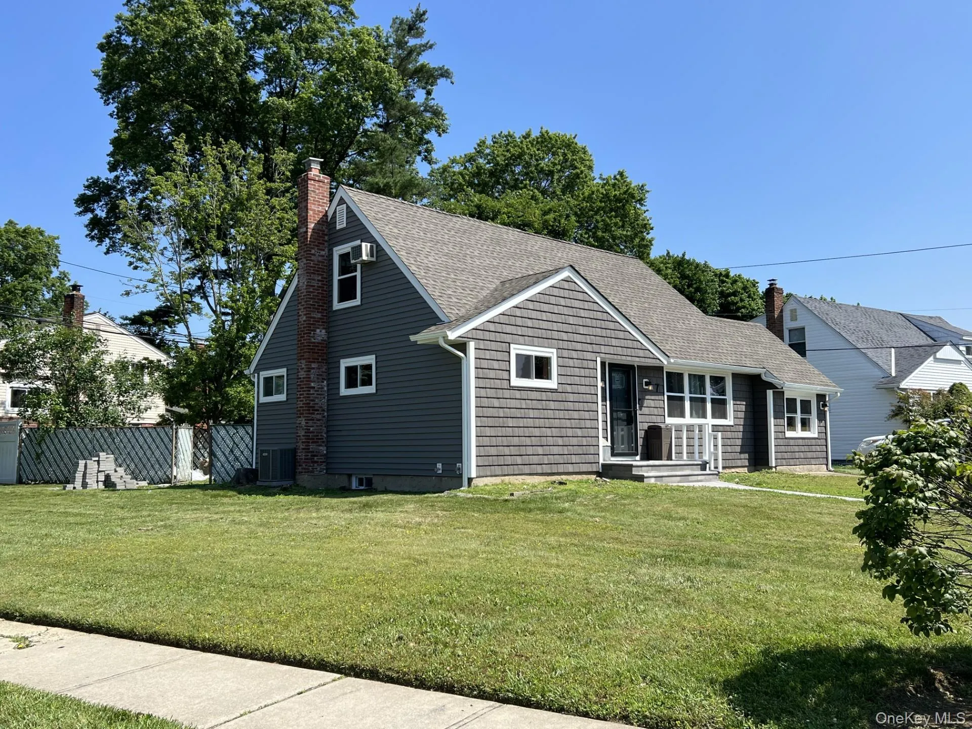 View of front of house with a chimney and a shingled roof View of front of house with a chimney and a shingled roof