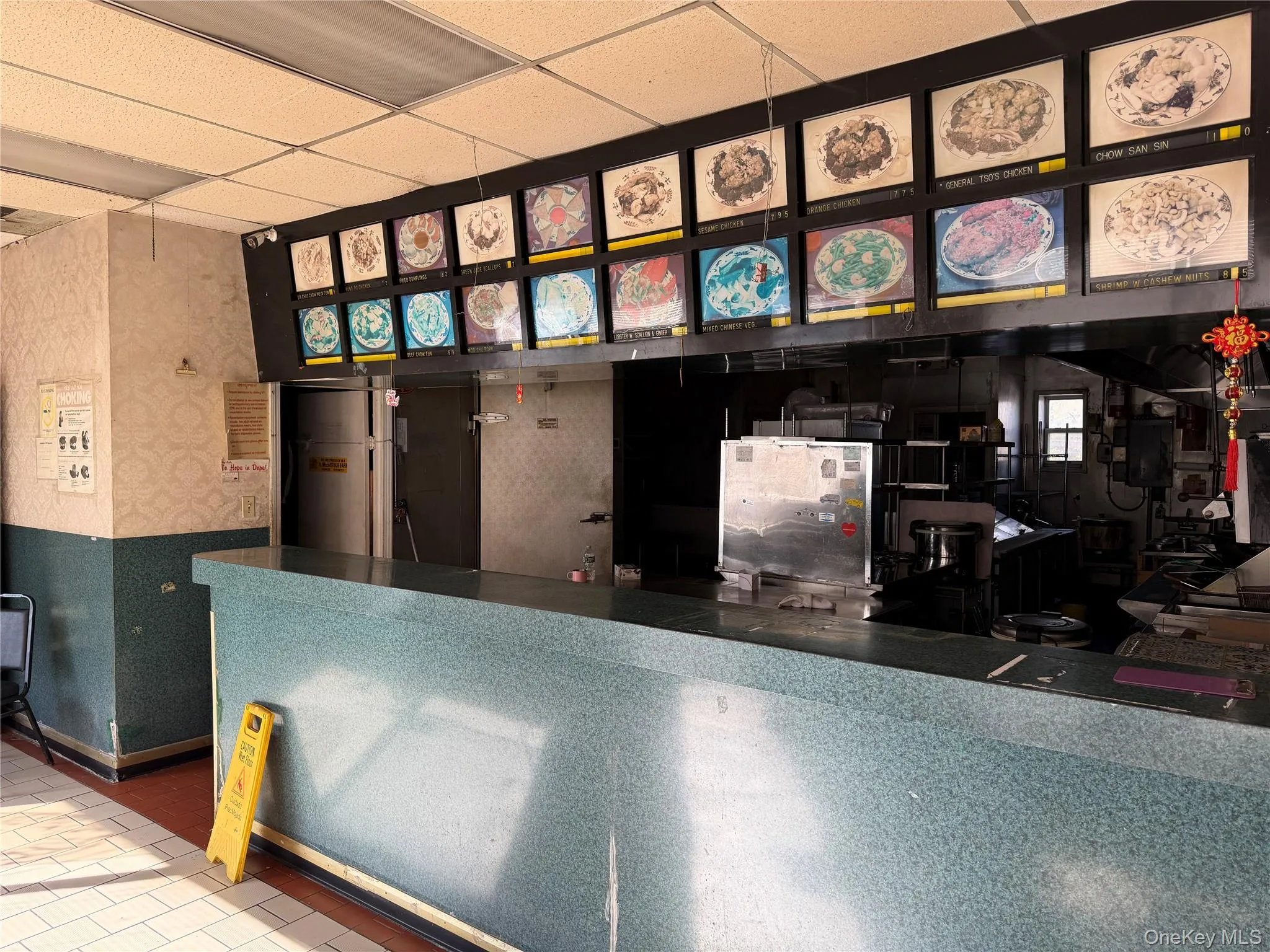 Reception area featuring wallpapered walls and a drop ceiling Reception area featuring wallpapered walls and a drop ceiling