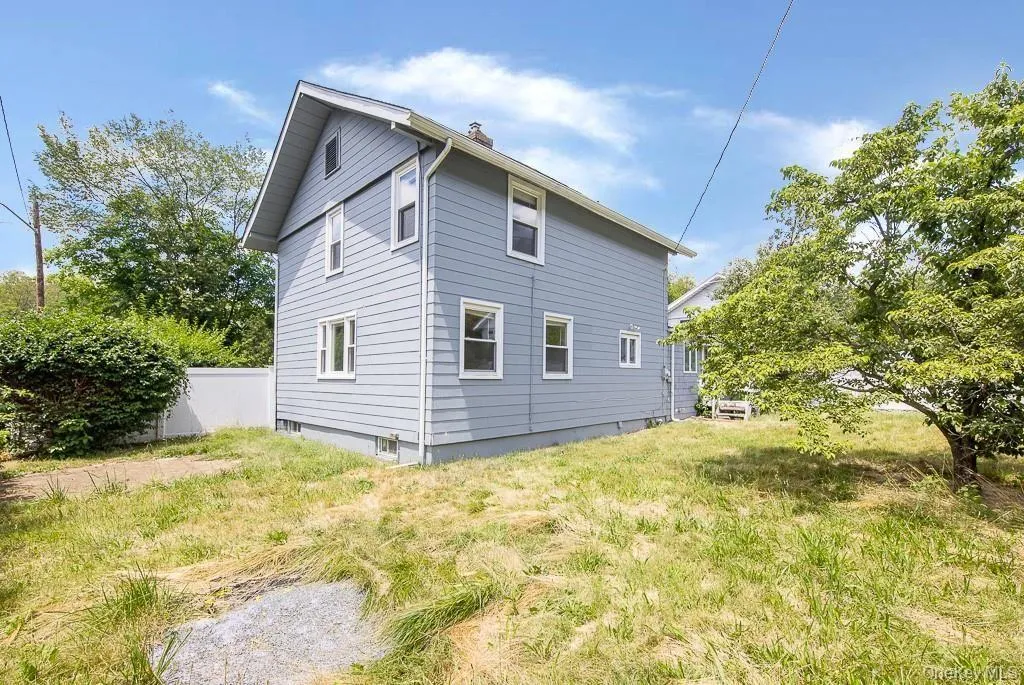View of side of property featuring a chimney View of side of property featuring a chimney