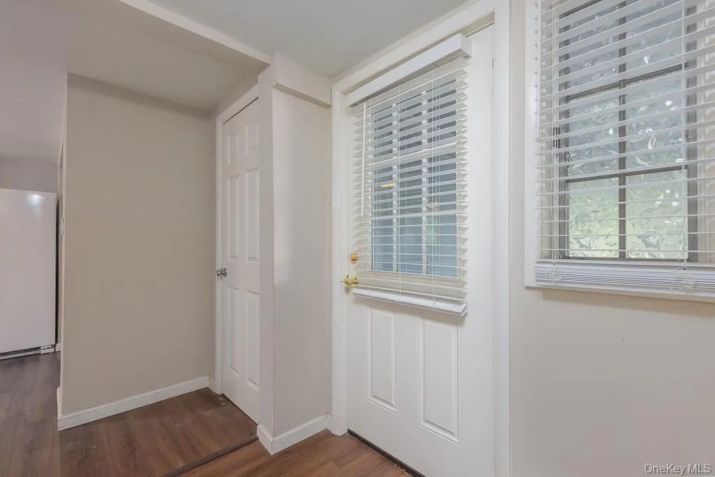 Doorway with wood finished floors and baseboards Doorway with wood finished floors and baseboards