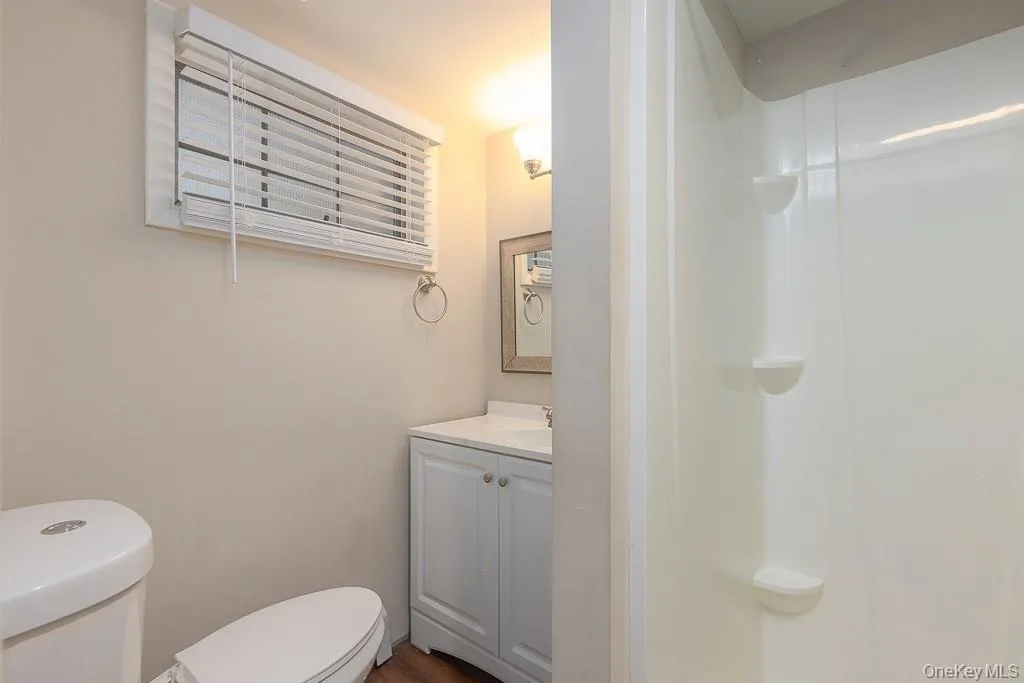 Bathroom featuring vanity and a shower stall Bathroom featuring vanity and a shower stall