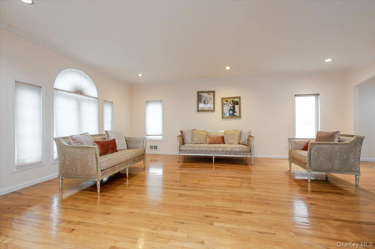 Living area with crown molding, light wood finished floors, and recessed lighting Living area with crown molding, light wood finished floors, and recessed lighting
