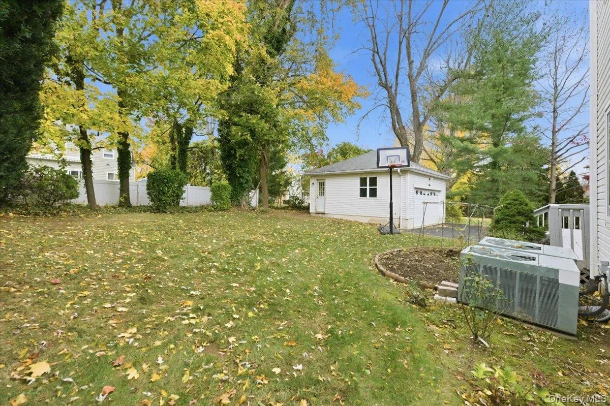 View of yard featuring an outdoor structure and a garage View of yard featuring an outdoor structure and a garage