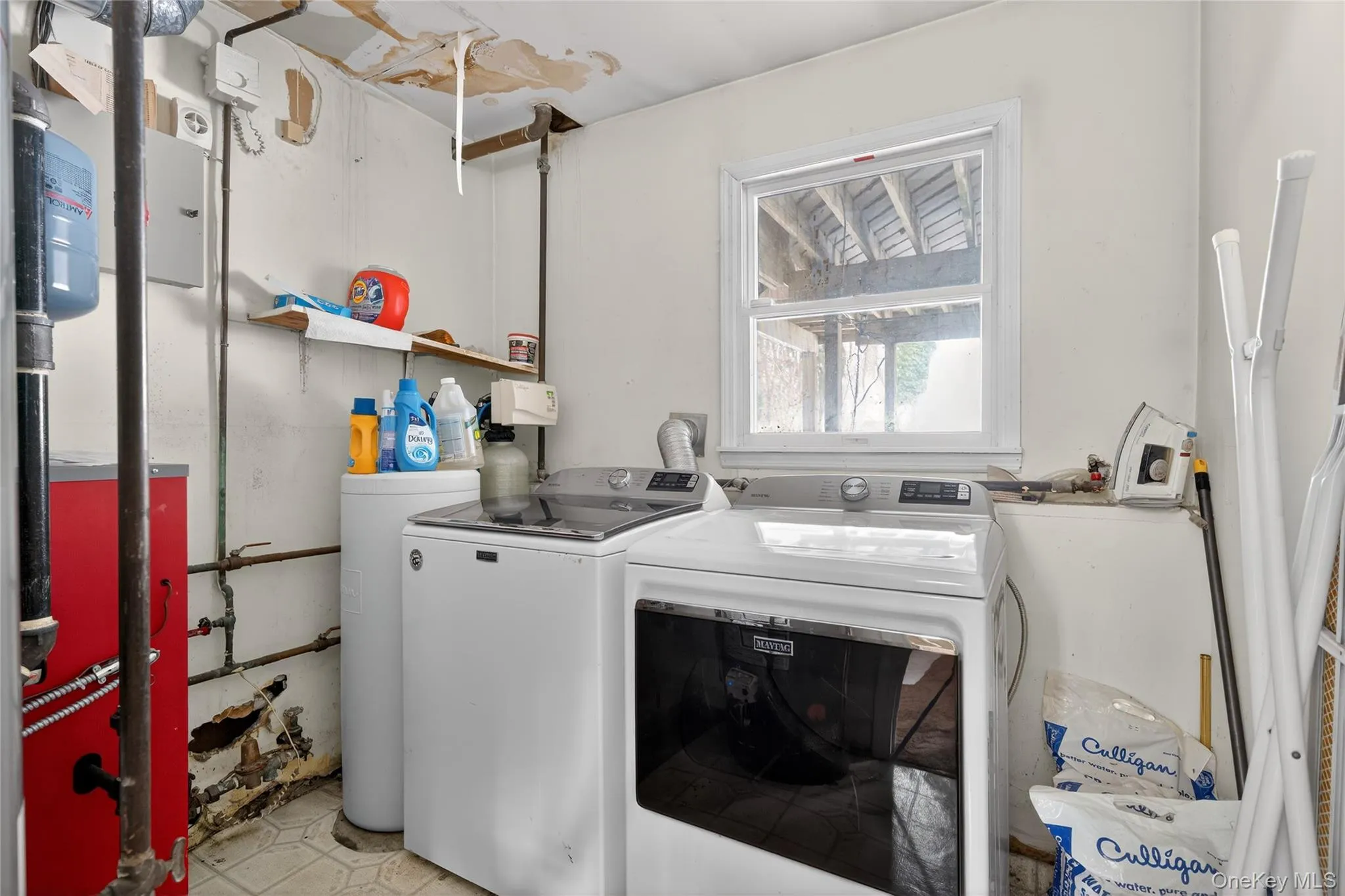 Laundry room featuring a heating unit and washer and dryer Laundry room featuring a heating unit and washer and dryer