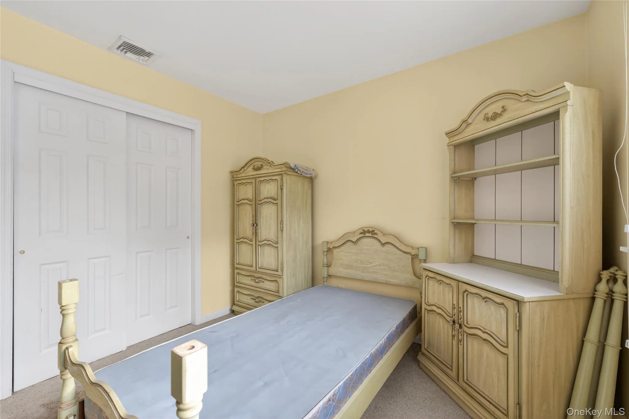 Bedroom with light carpet and a closet Bedroom with light carpet and a closet