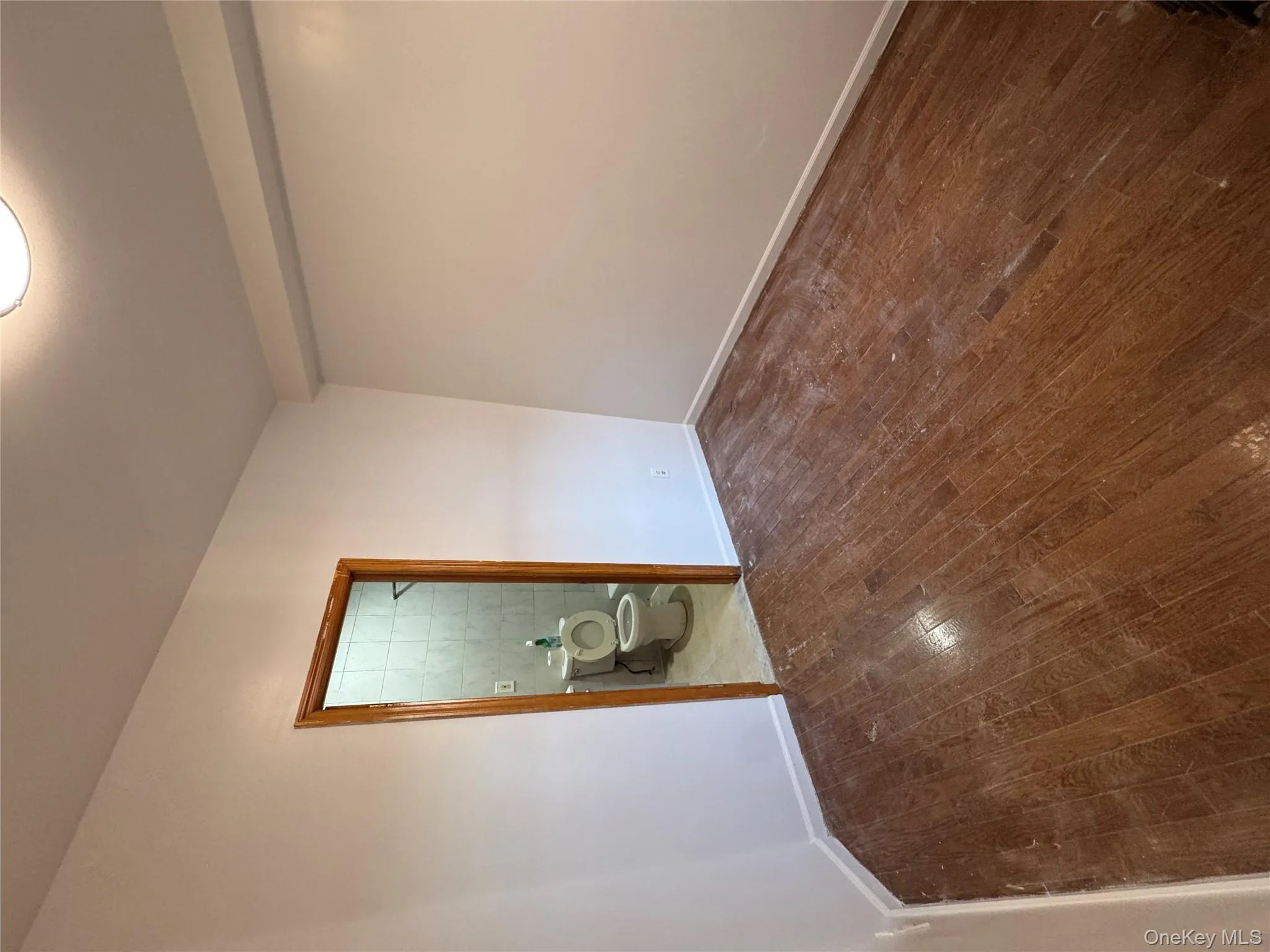 Unfurnished room with dark wood finished floors and baseboards Unfurnished room with dark wood finished floors and baseboards