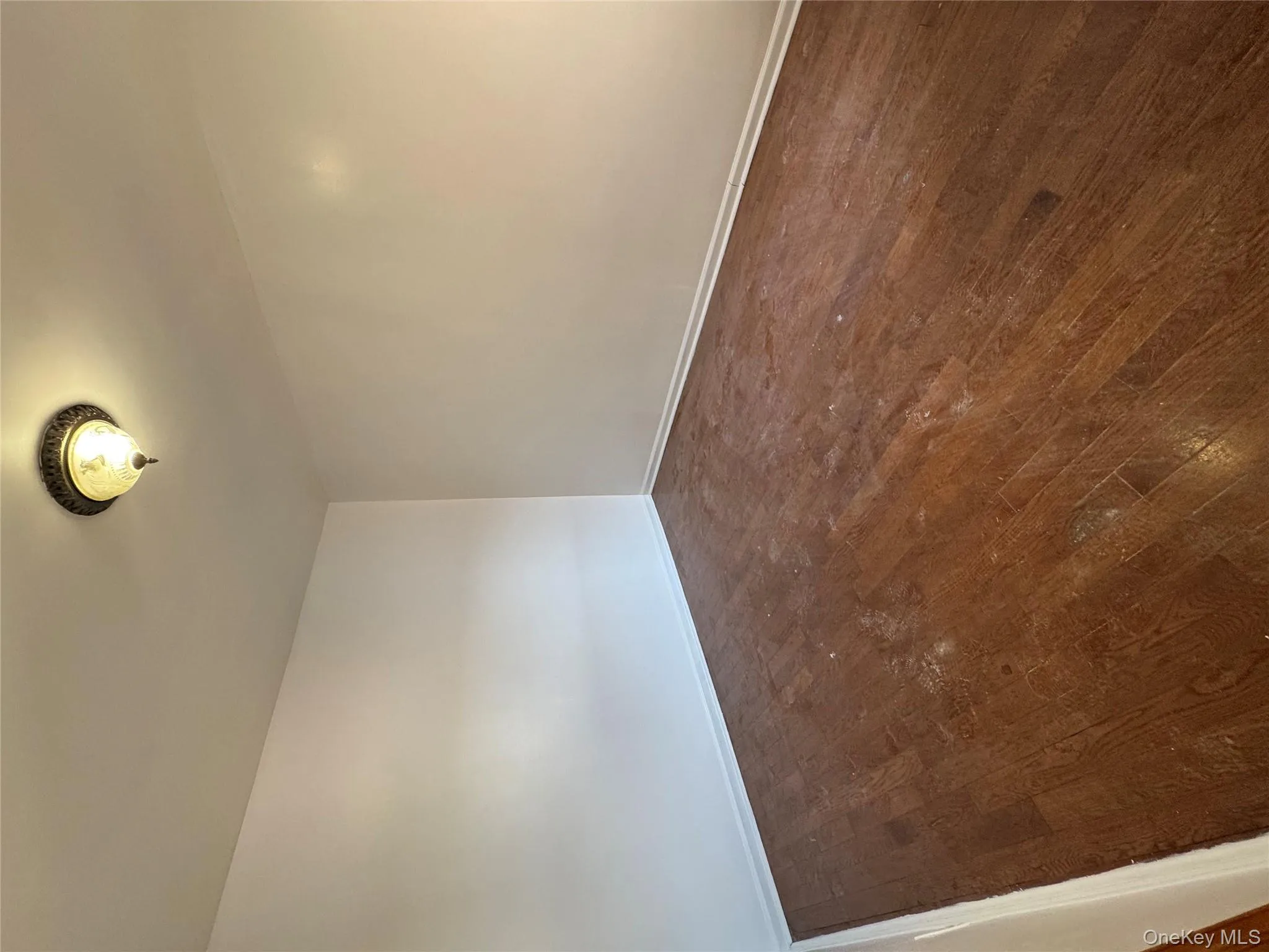 Unfurnished room with dark wood-type flooring and baseboards Unfurnished room with dark wood-type flooring and baseboards