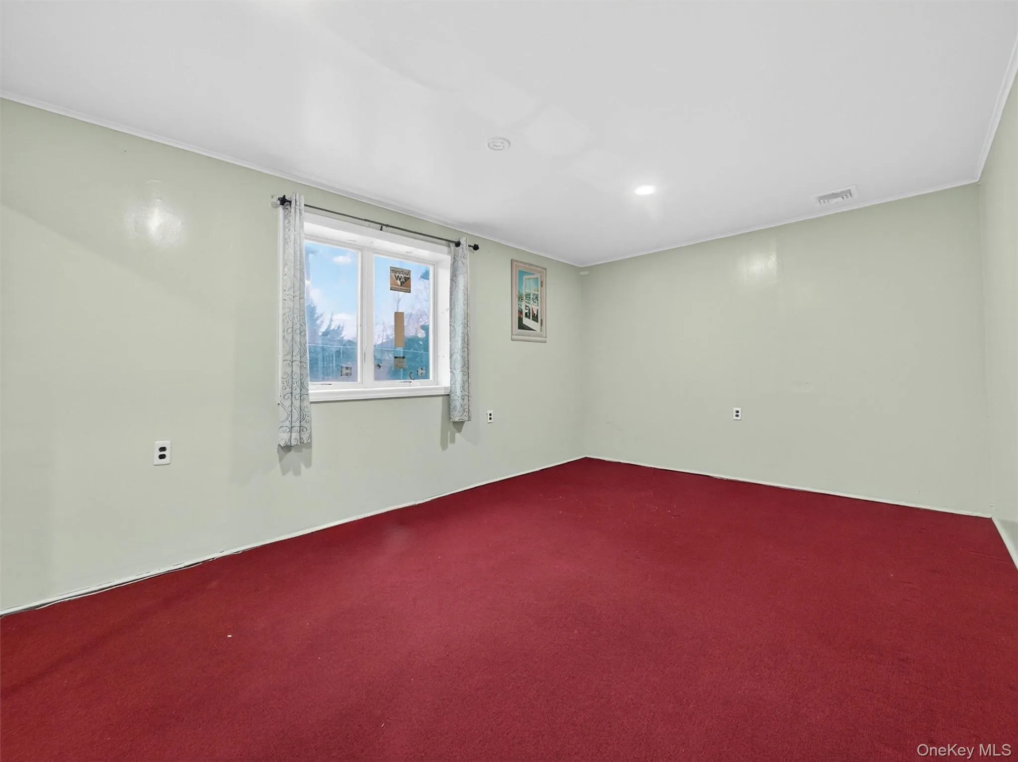 Carpeted empty room featuring ornamental molding Carpeted empty room featuring ornamental molding