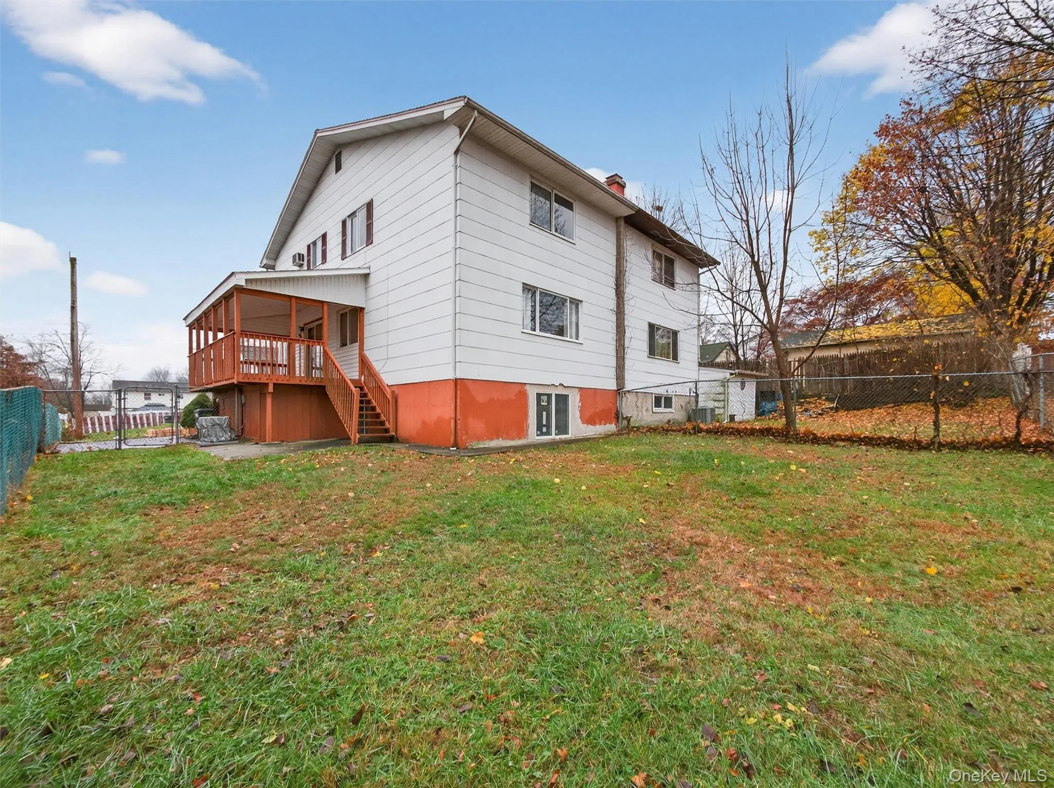 Rear view of property featuring a fenced backyard, stairway, and a chimney Rear view of property featuring a fenced backyard, stairway, and a chimney