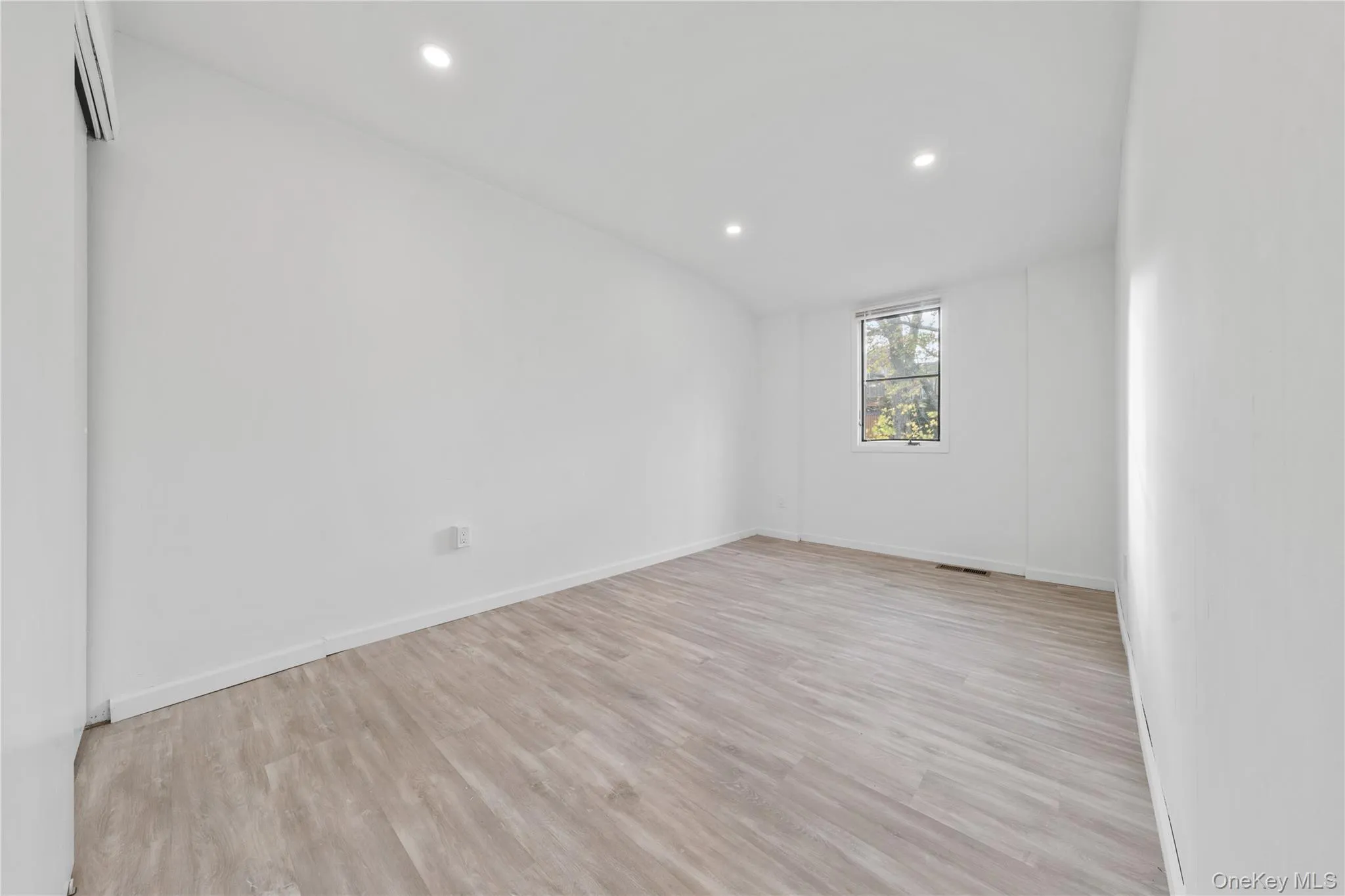 Empty room with light wood-style floors and recessed lighting Empty room with light wood-style floors and recessed lighting
