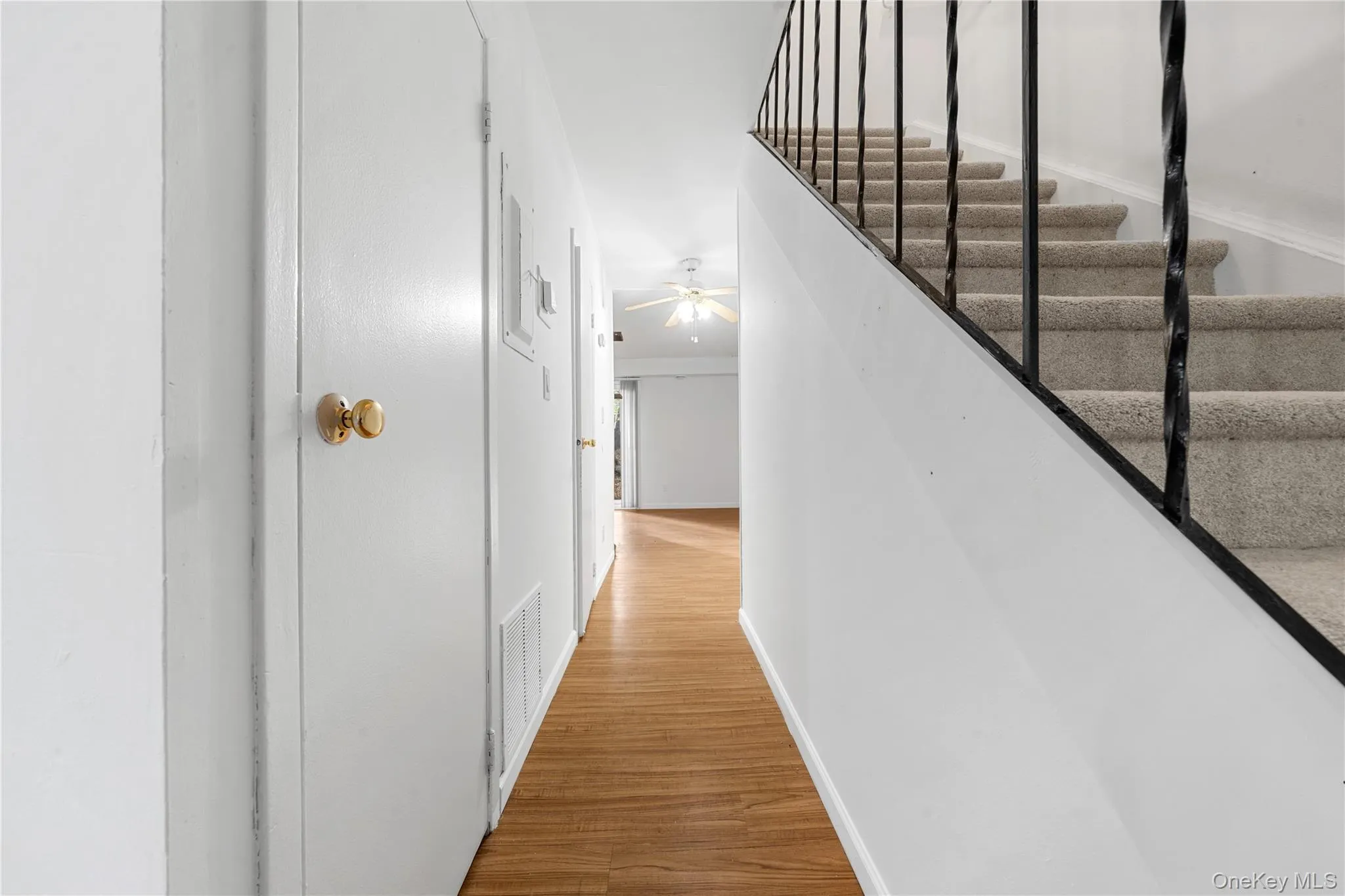 Corridor featuring light wood-type flooring and stairway Corridor featuring light wood-type flooring and stairway