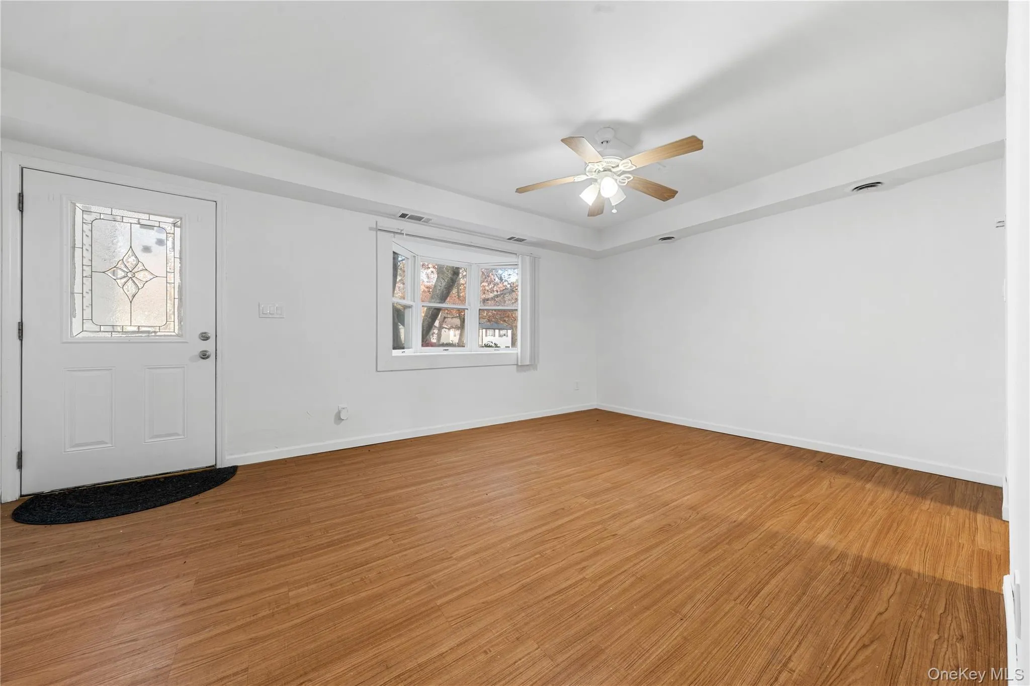 Entryway featuring light wood-style floors and a ceiling fan Entryway featuring light wood-style floors and a ceiling fan