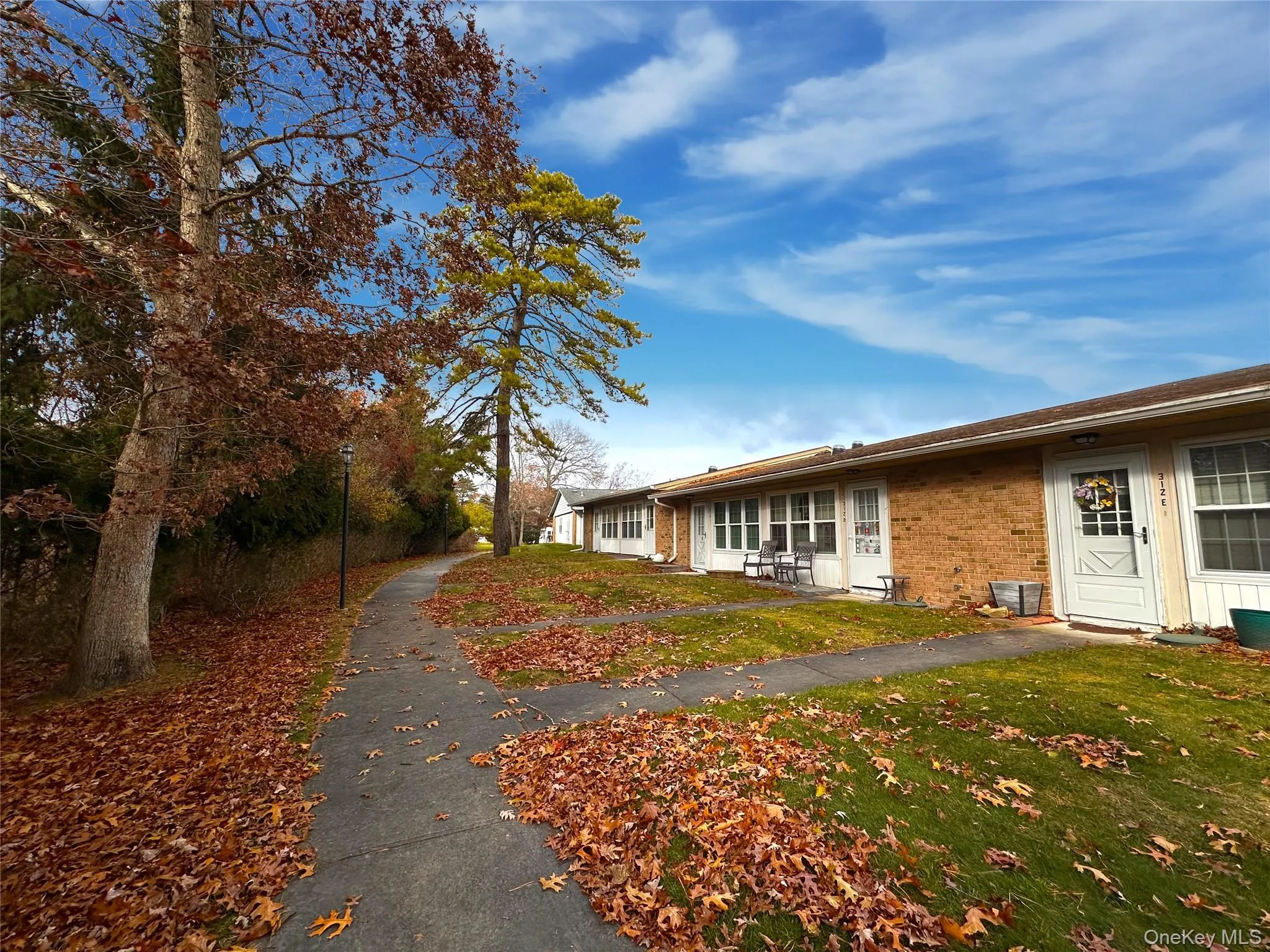 View of property exterior featuring brick siding and a lawn View of property exterior featuring brick siding and a lawn