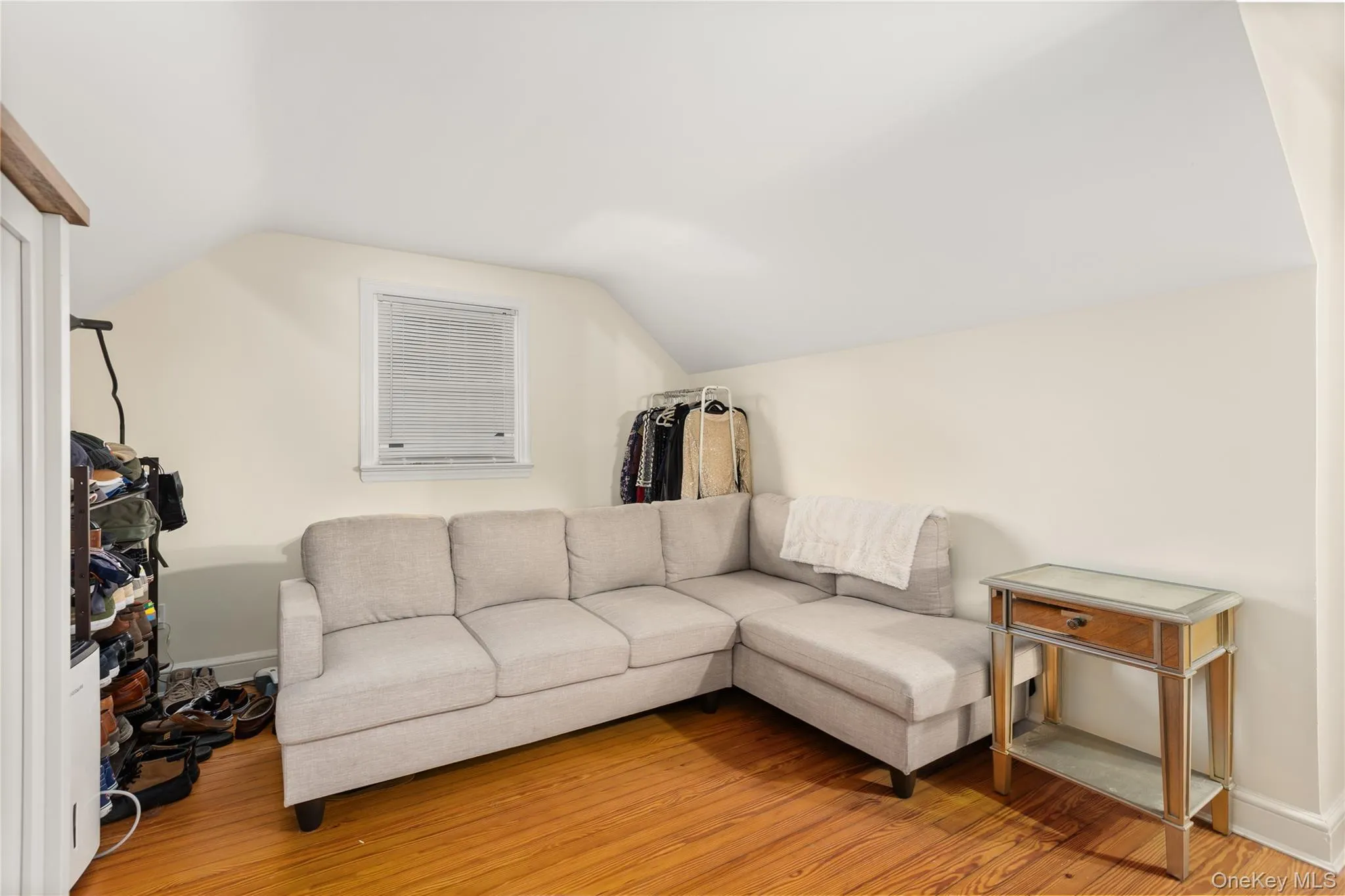 Living room featuring vaulted ceiling and light wood-style flooring Living room featuring vaulted ceiling and light wood-style flooring