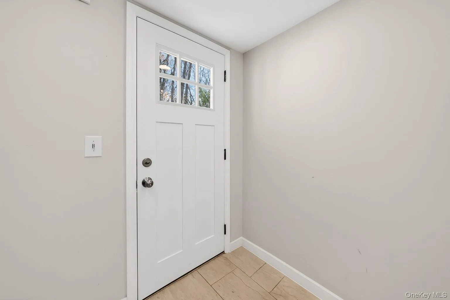 Doorway with baseboards and tile patterned flooring Doorway with baseboards and tile patterned flooring