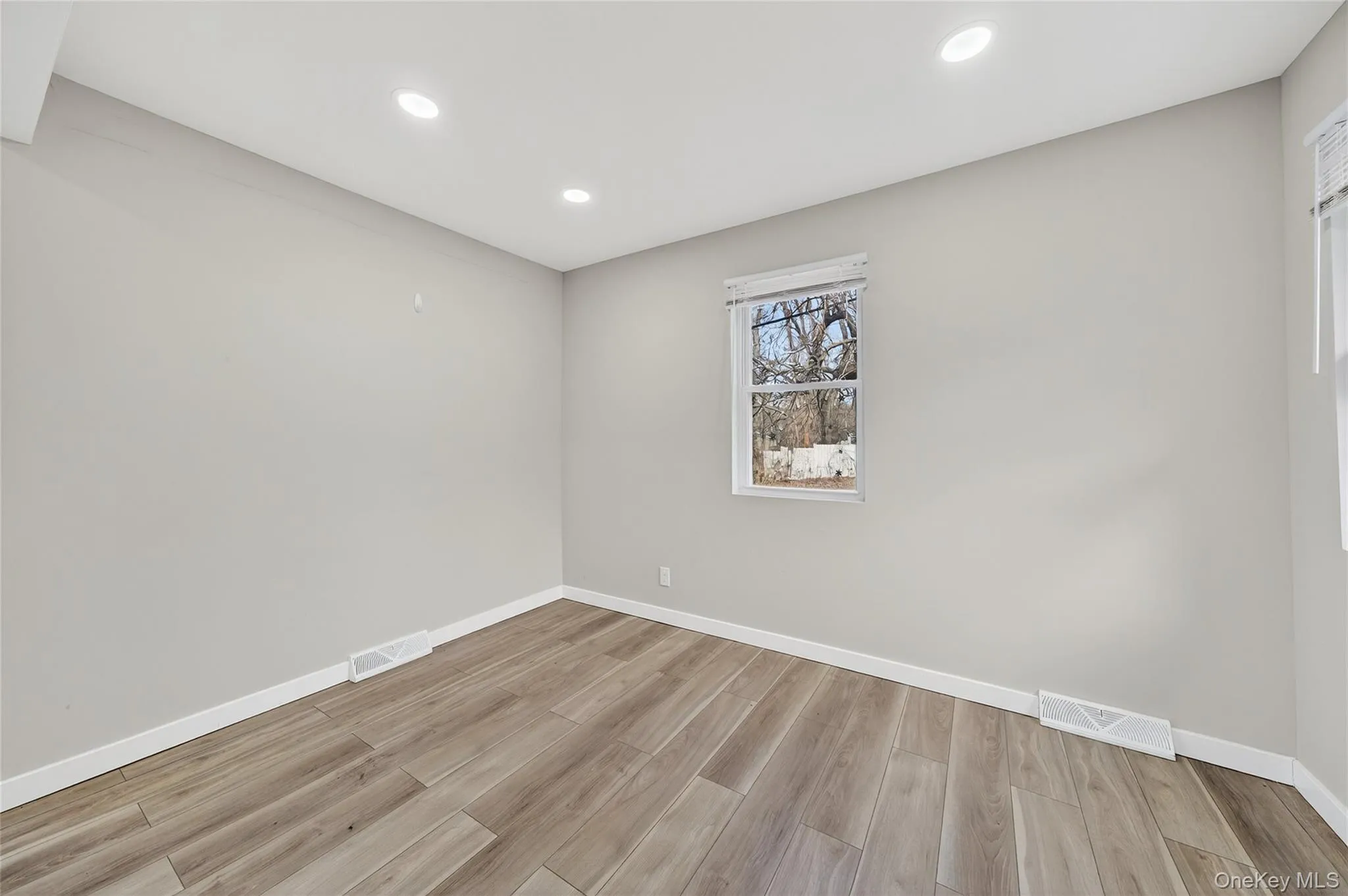 Spare room featuring recessed lighting and light wood-style floors Spare room featuring recessed lighting and light wood-style floors