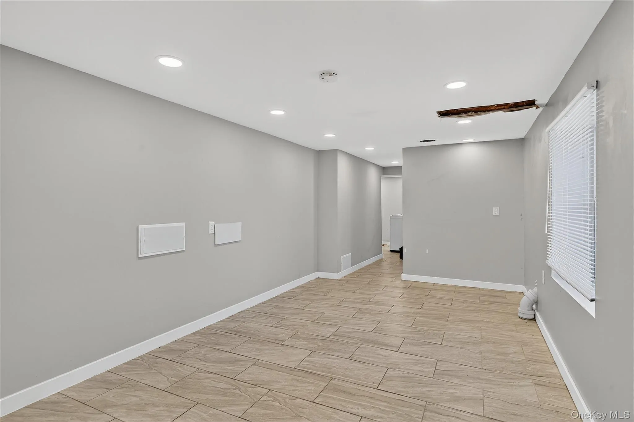 Unfurnished room with recessed lighting and wood tiled floors Unfurnished room with recessed lighting and wood tiled floors