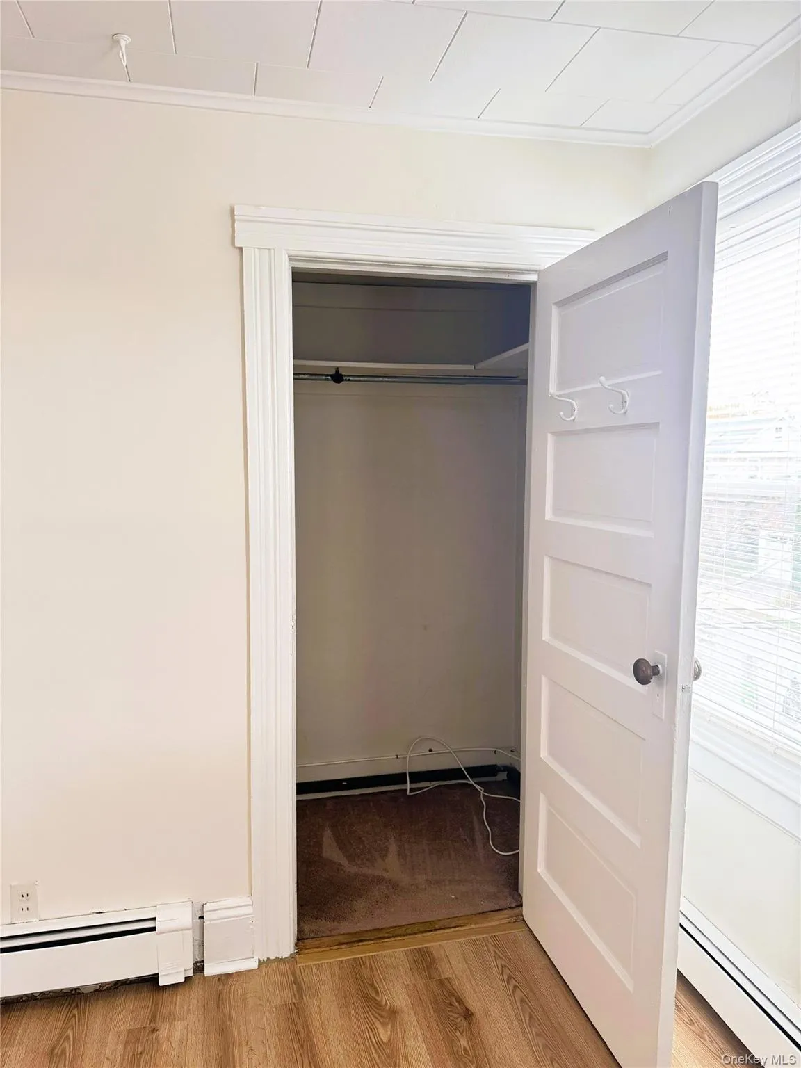 Closet featuring baseboard heating Closet featuring baseboard heating